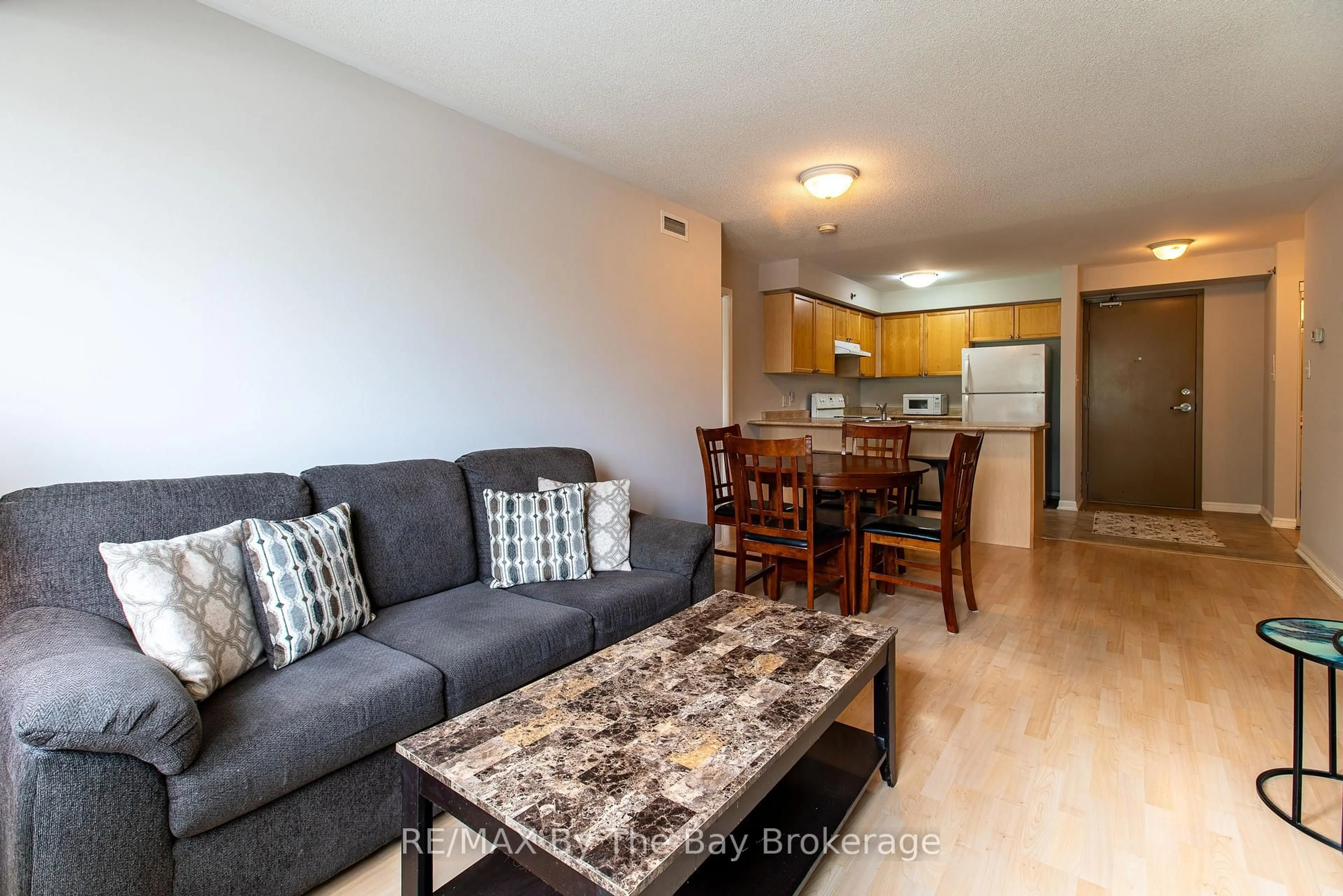Living room with furniture, wood/laminate floor for 16 Westbury Rd #211, Wasaga Beach Ontario L9Z 0B8