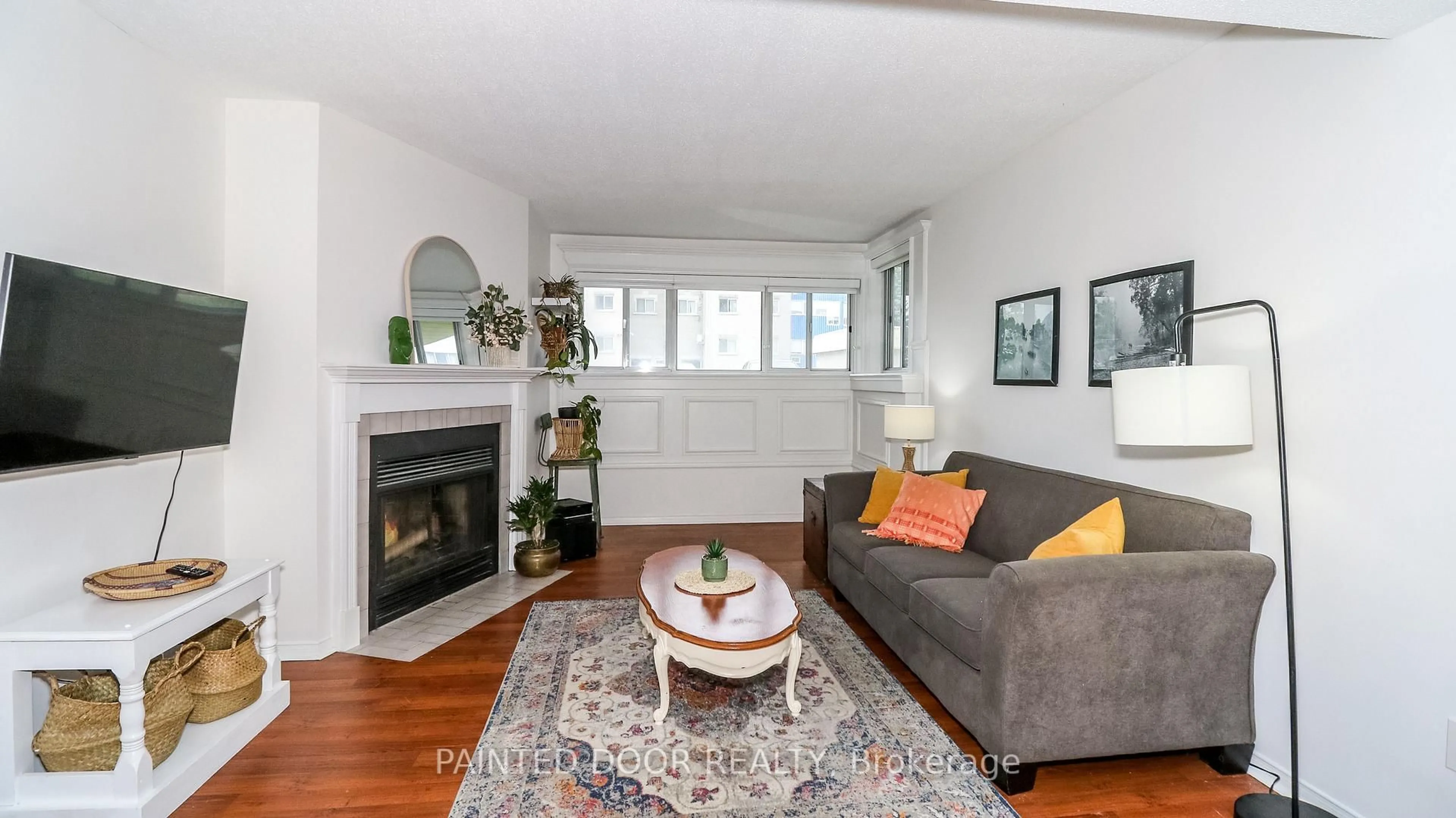 Living room with furniture, wood/laminate floor for 126 Bell Farm Rd #113, Barrie Ontario L4M 6J3