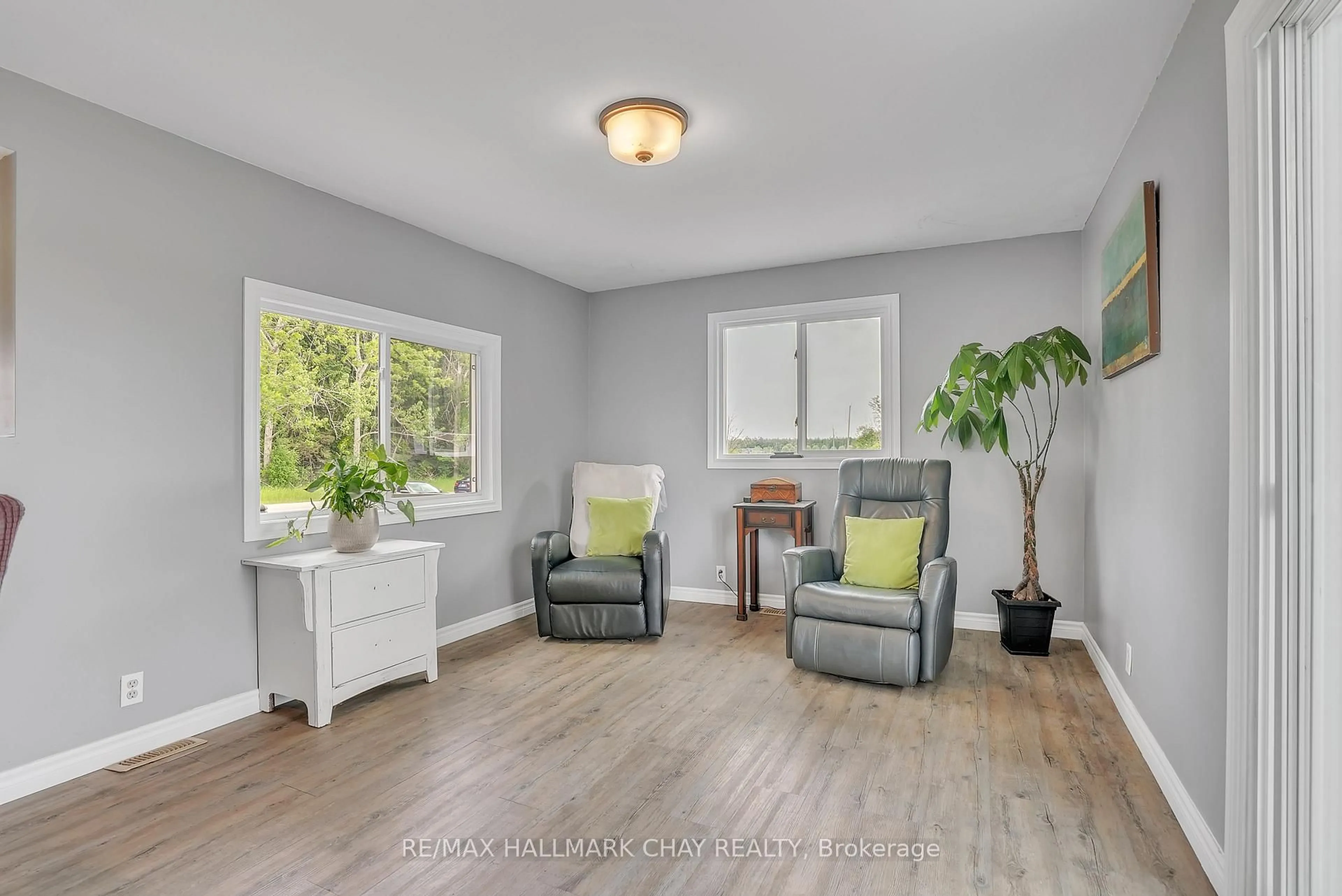 Living room with furniture, wood/laminate floor for 2533 Flos 3 Rd, Springwater Ontario L0L 2K0