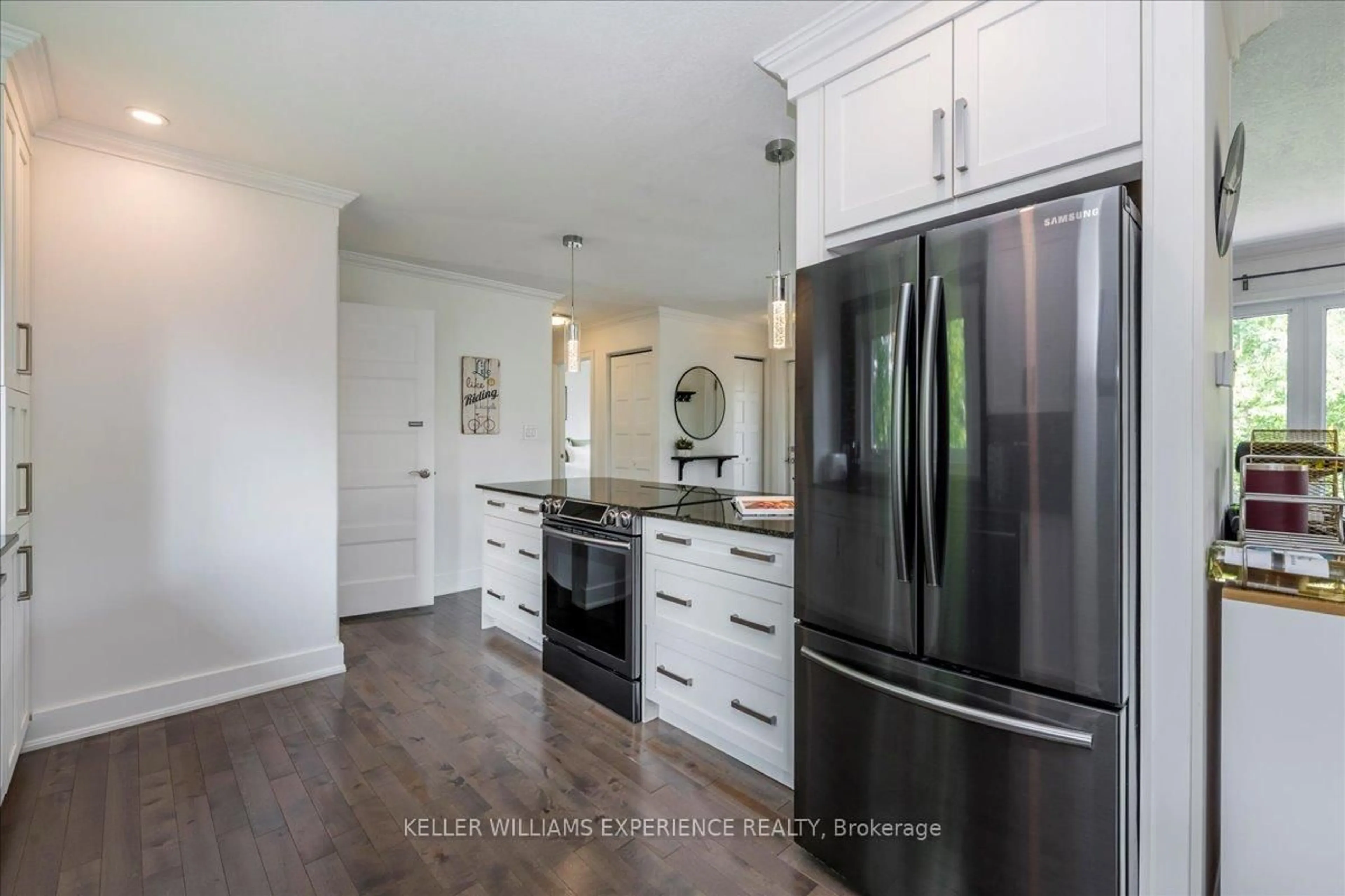Open concept kitchen, wood/laminate floor for 174 DUCKWORTH St, Barrie Ontario L4M 3W5