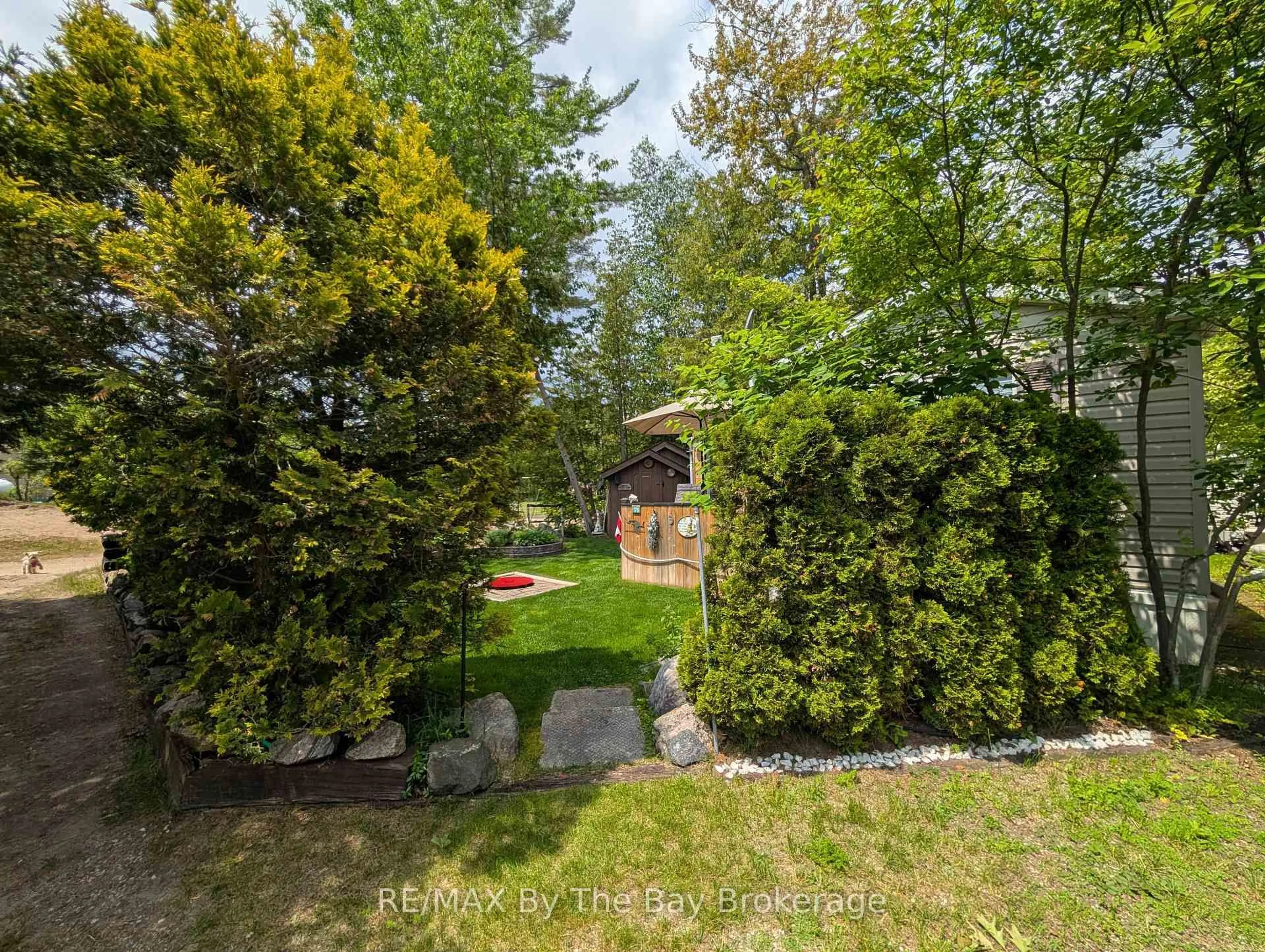A pic from outside/outdoor area/front of a property/back of a property/a pic from drone, forest/trees view for 85 Theme Park Dr #179, Wasaga Beach Ontario L9Z 1X7