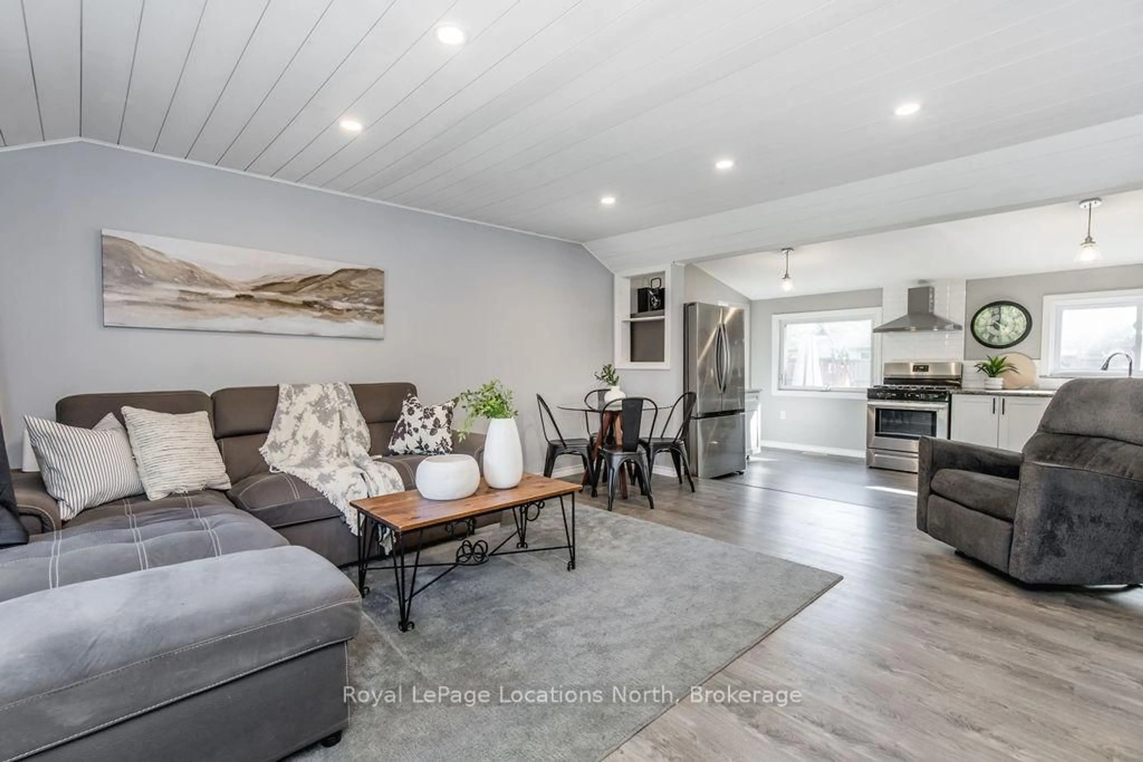 Living room with furniture, wood/laminate floor for 497 OXBOW PARK Dr, Wasaga Beach Ontario L9Z 2T9