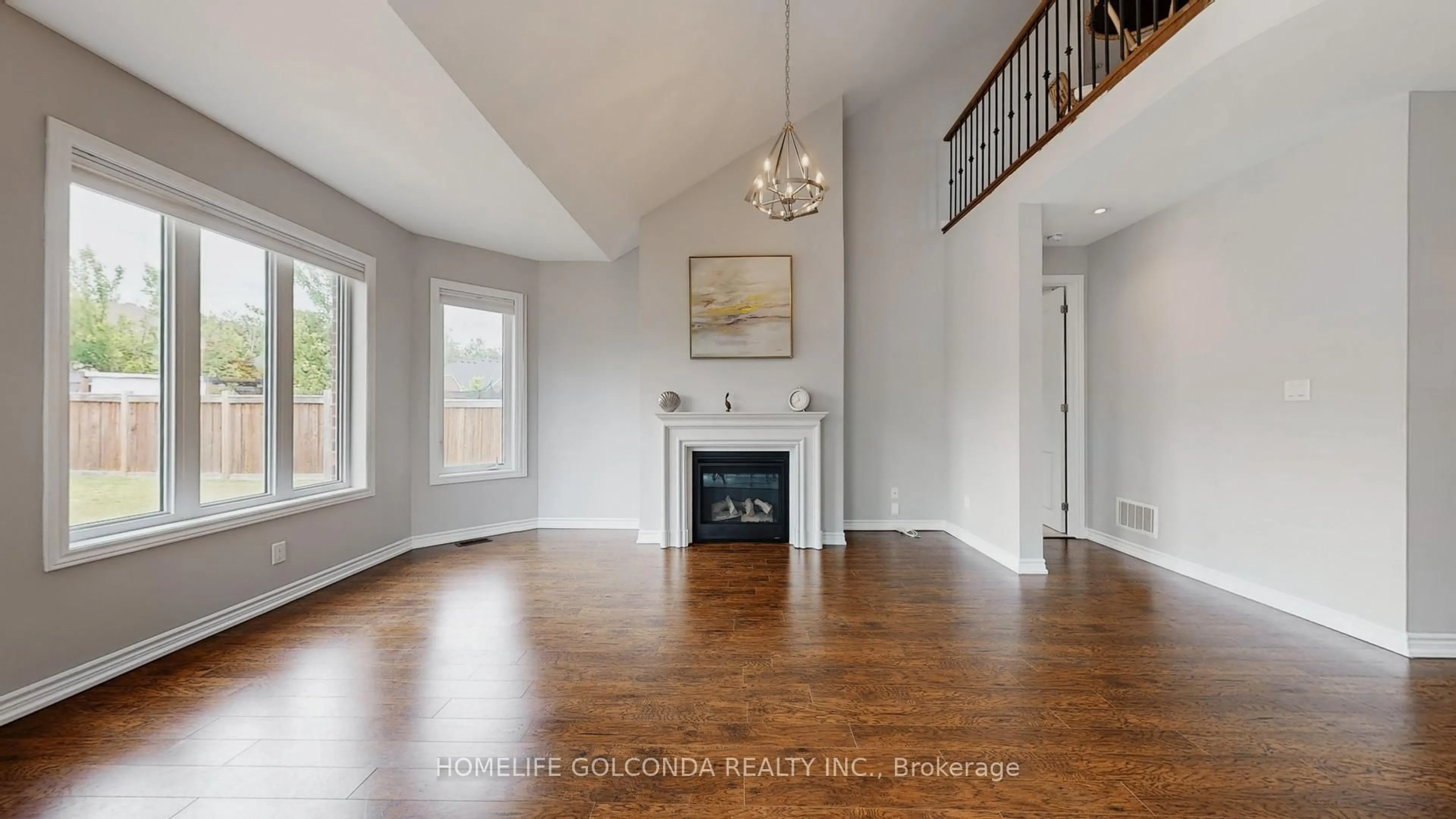 Living room with furniture, wood/laminate floor for 76 Victoria Wood Ave, Springwater Ontario L9X 1Z8
