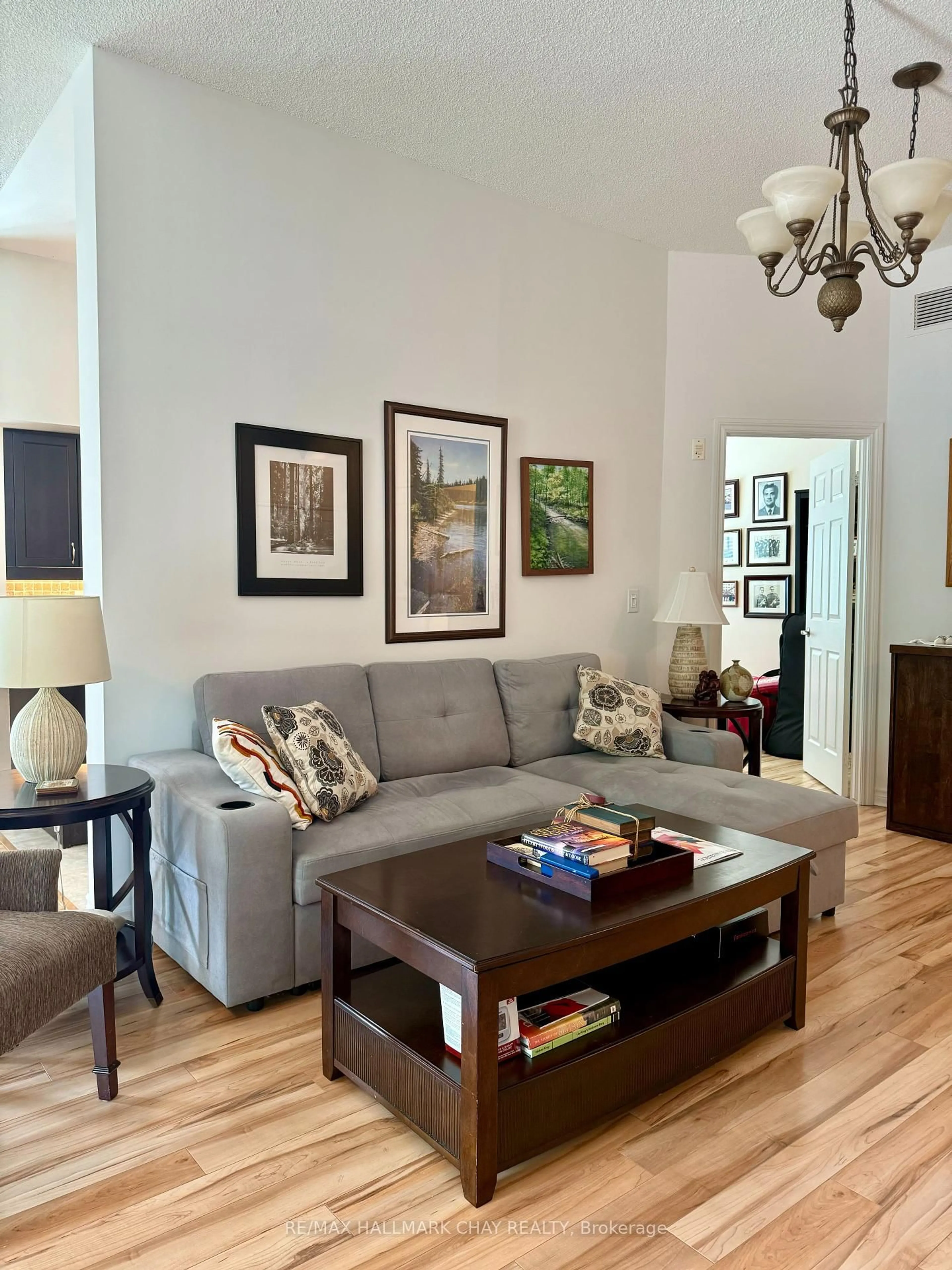 Living room with furniture, wood/laminate floor for 354 Atherley Rd #102, Orillia Ontario L3V 0B8