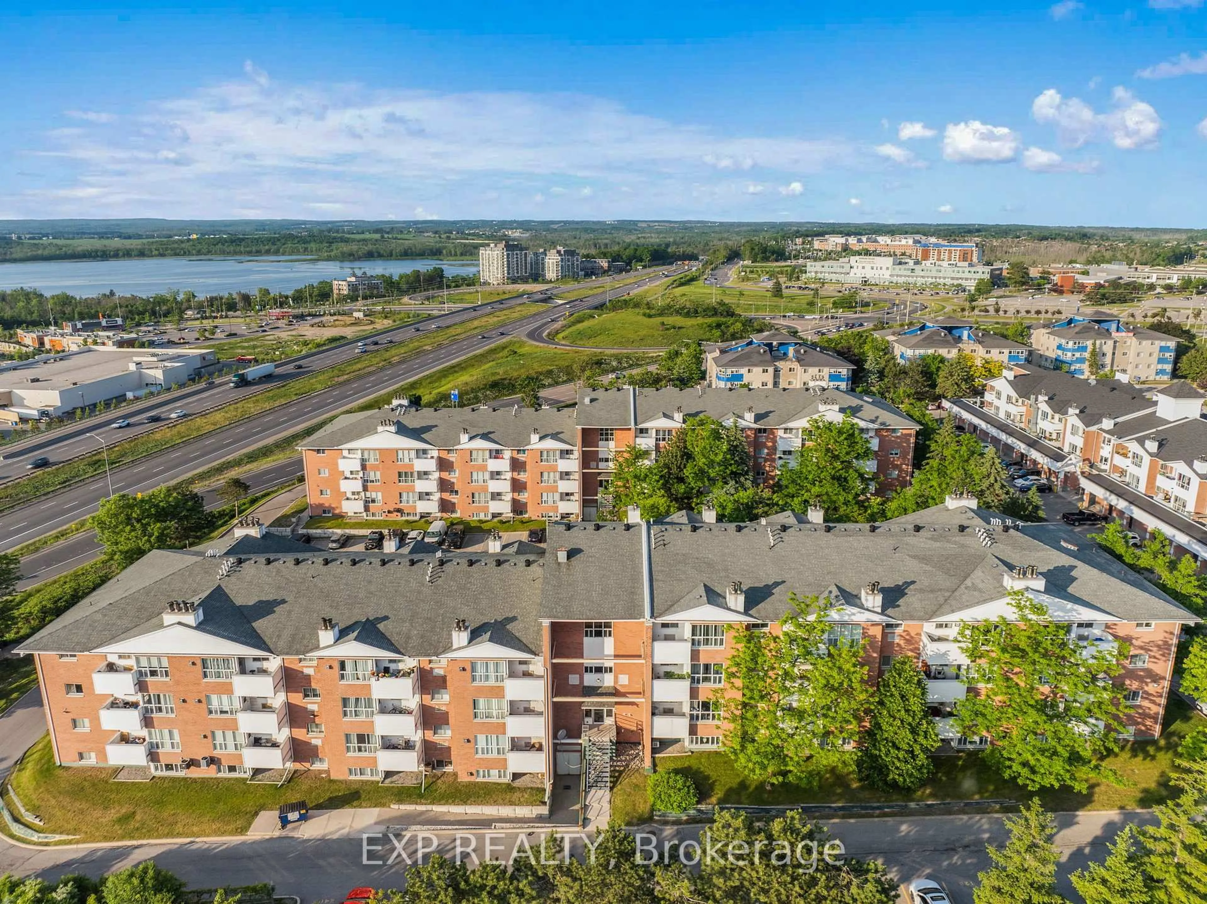 A pic from outside/outdoor area/front of a property/back of a property/a pic from drone, water/lake/river/ocean view for 120 Bell Farm Rd #201, Barrie Ontario L4M 6J2