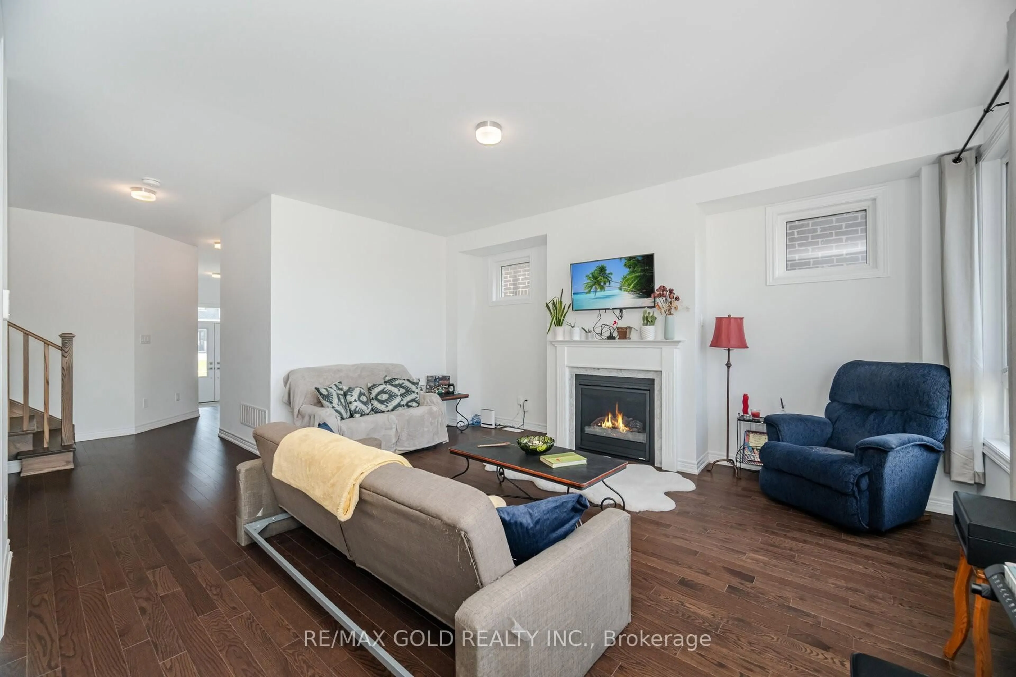 Living room with furniture, wood/laminate floor for 155 Fenchurch Manr, Barrie Ontario L9J 0W9