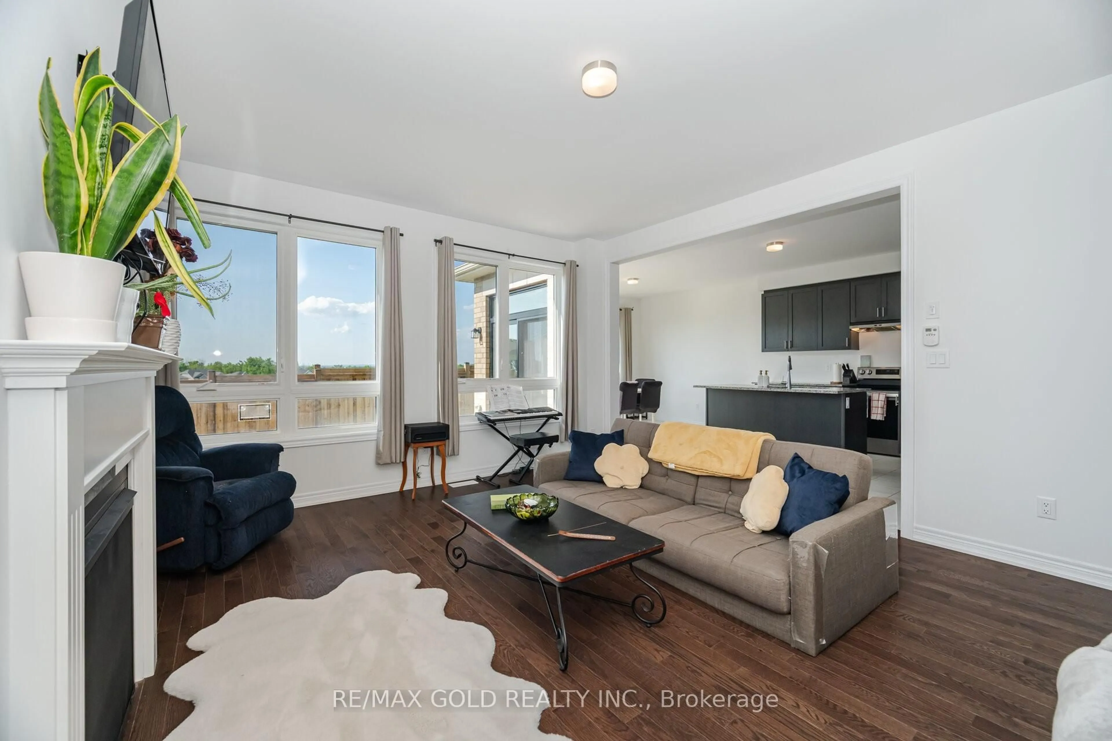 Living room with furniture, wood/laminate floor for 155 Fenchurch Manr, Barrie Ontario L9J 0W9