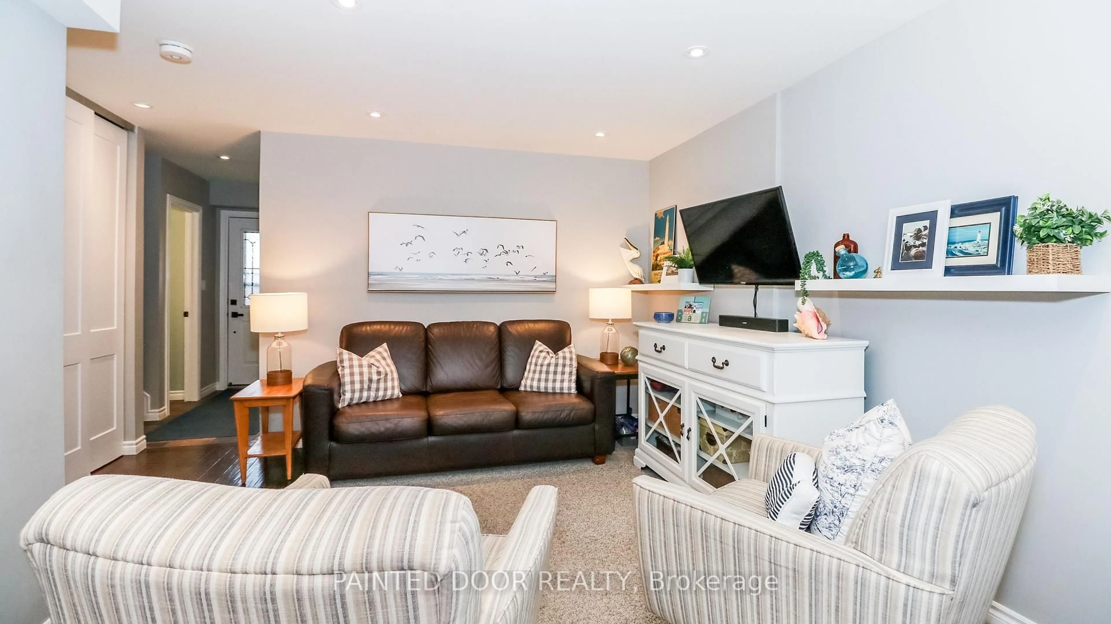 Living room with furniture, wood/laminate floor for 28 Donald St #63, Barrie Ontario L4N 4S6