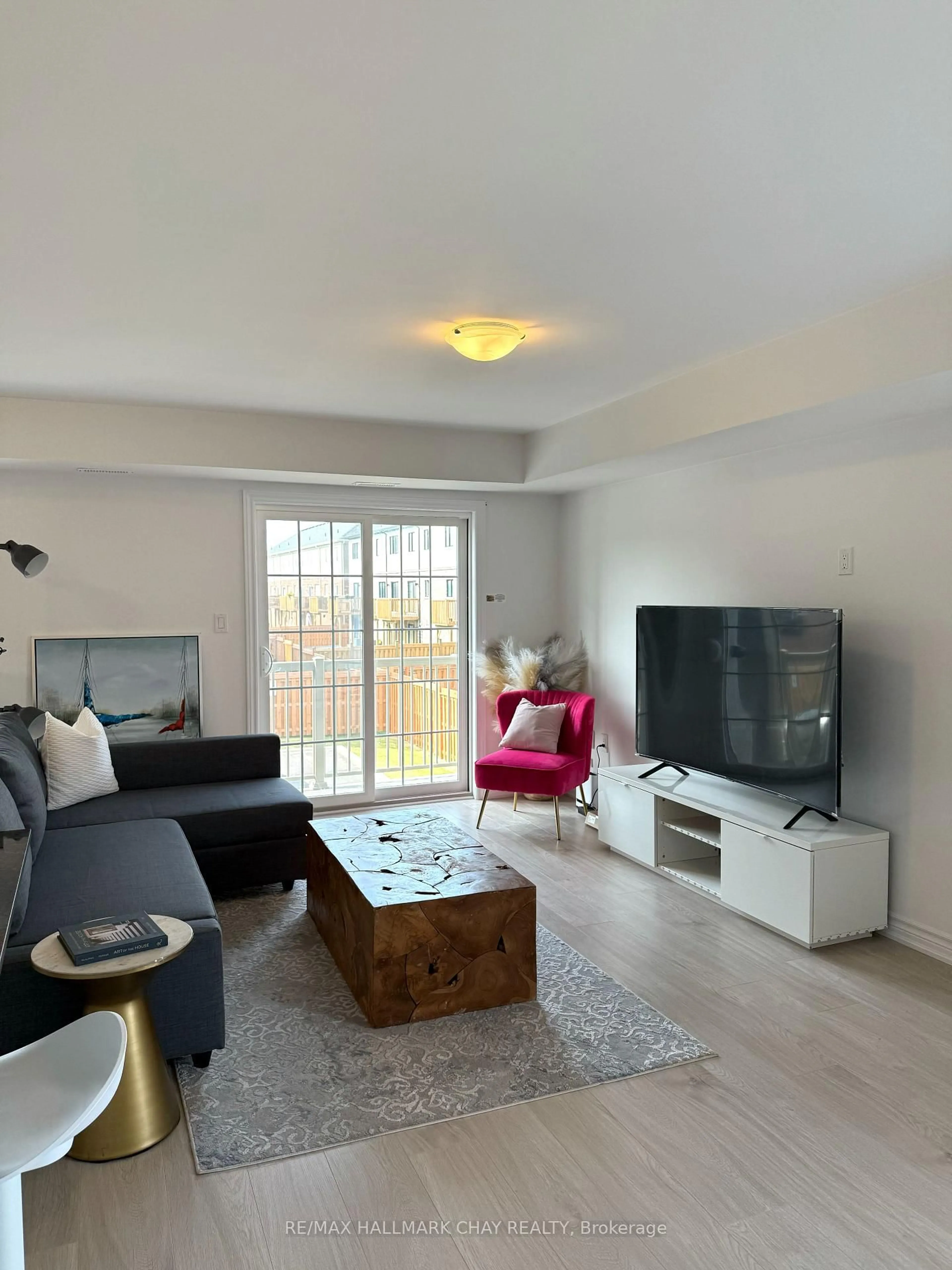 Living room with furniture, wood/laminate floor for 31 Pumpkin Corner Cres #2, Barrie Ontario L9J 0T5