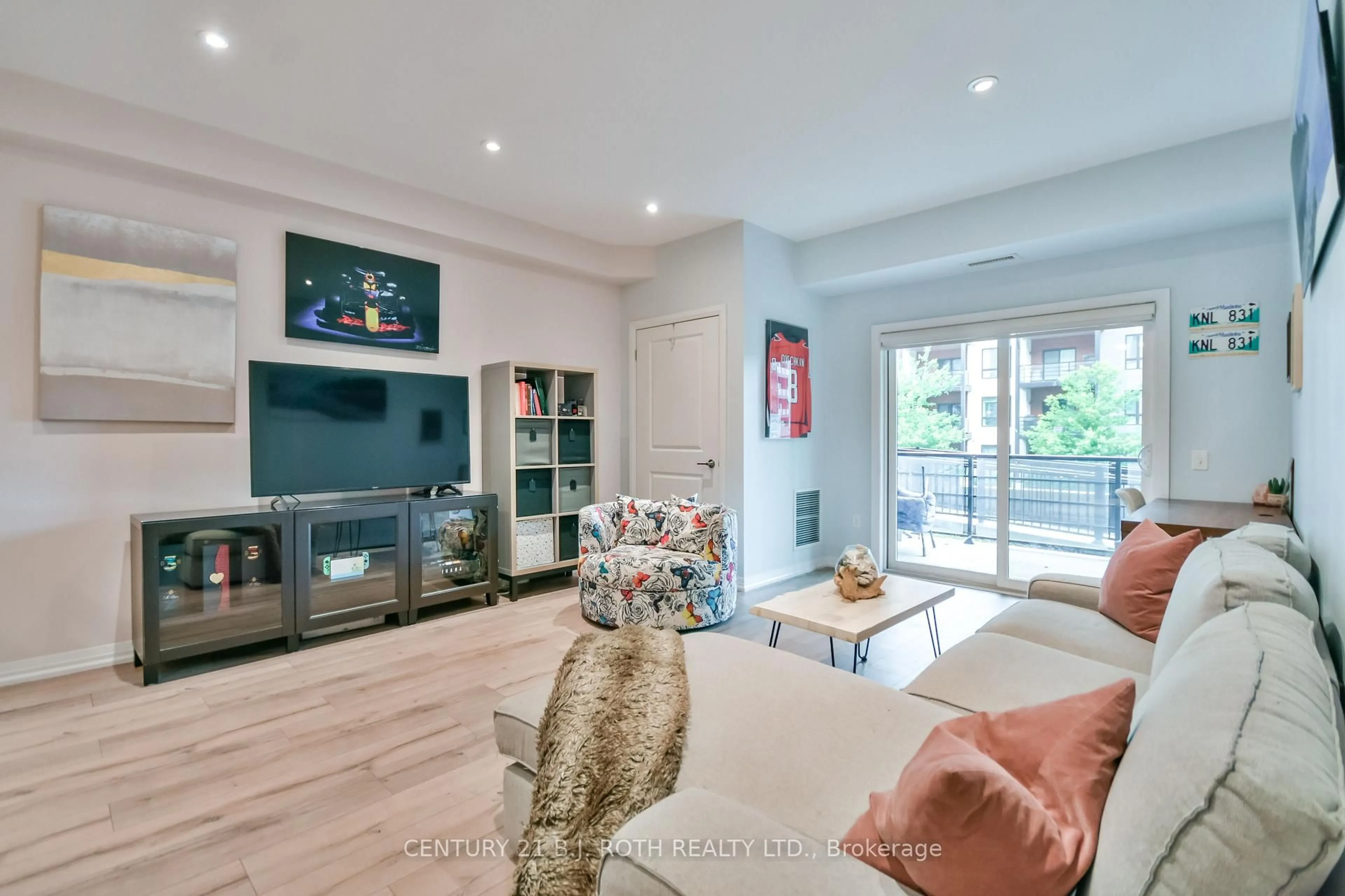 Living room with furniture, wood/laminate floor for 306 Essa Rd #107, Barrie Ontario L9J 0H5