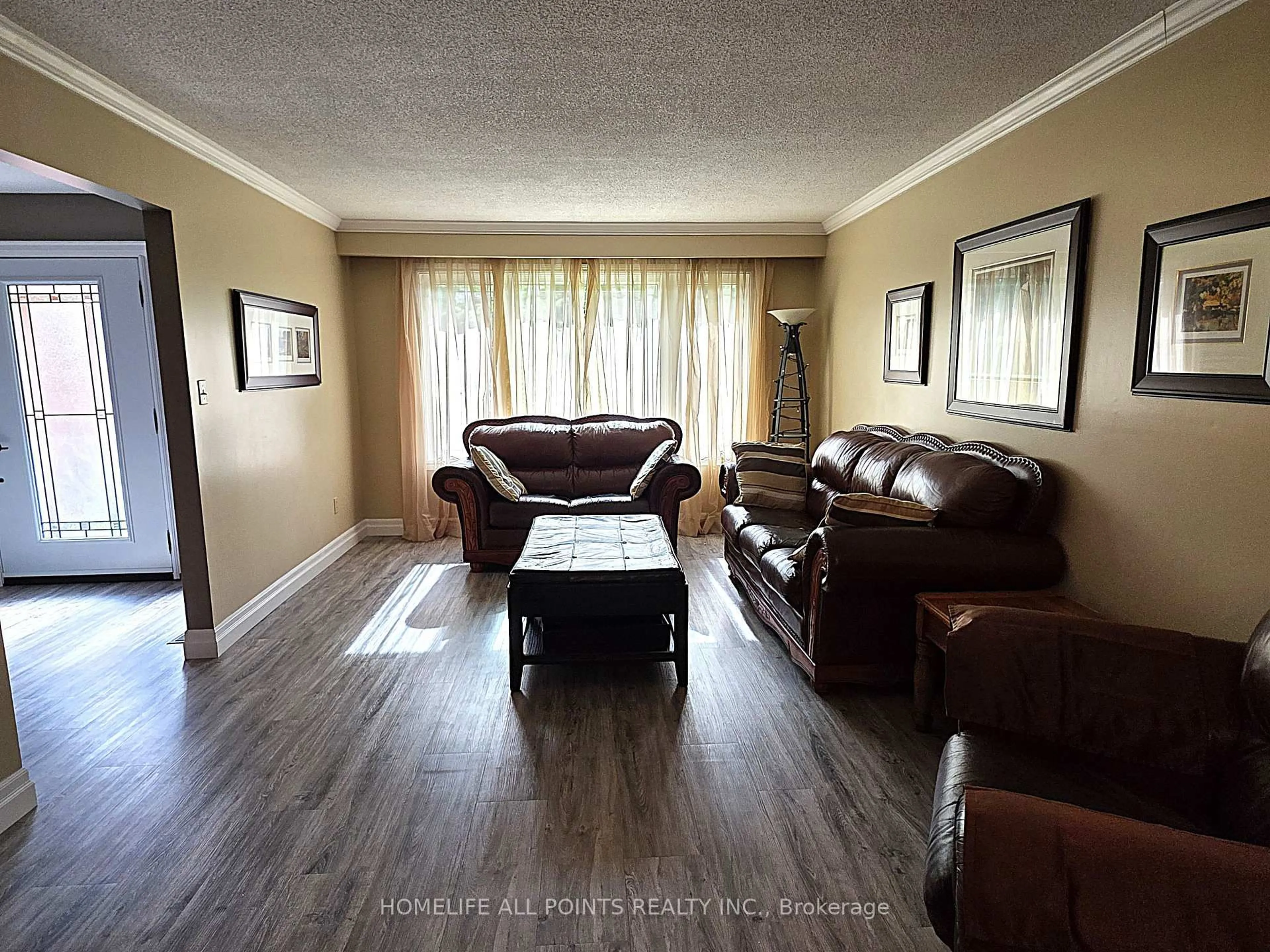 Living room with furniture, wood/laminate floor for 188 BROWNING Tr, Barrie Ontario L4N 5H2