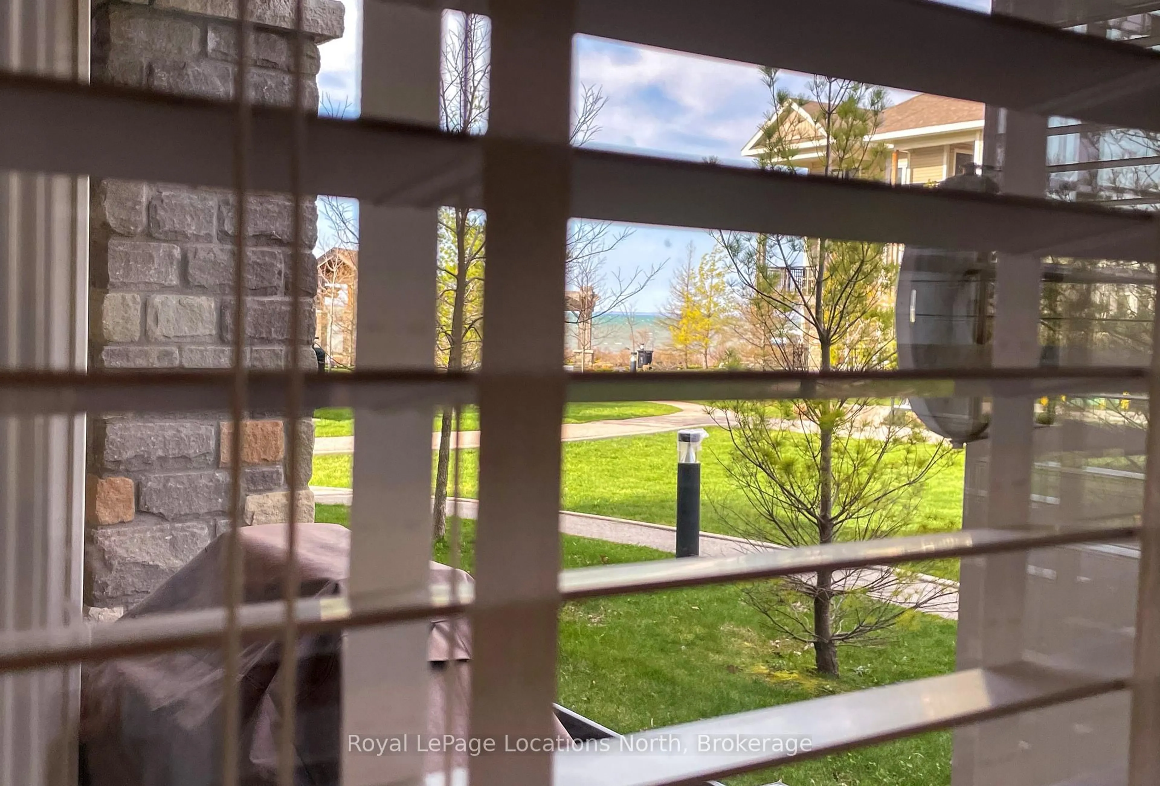 Patio, city buildings view from balcony for 5 Anchorage Cres #102, Collingwood Ontario L9Y 0Y6