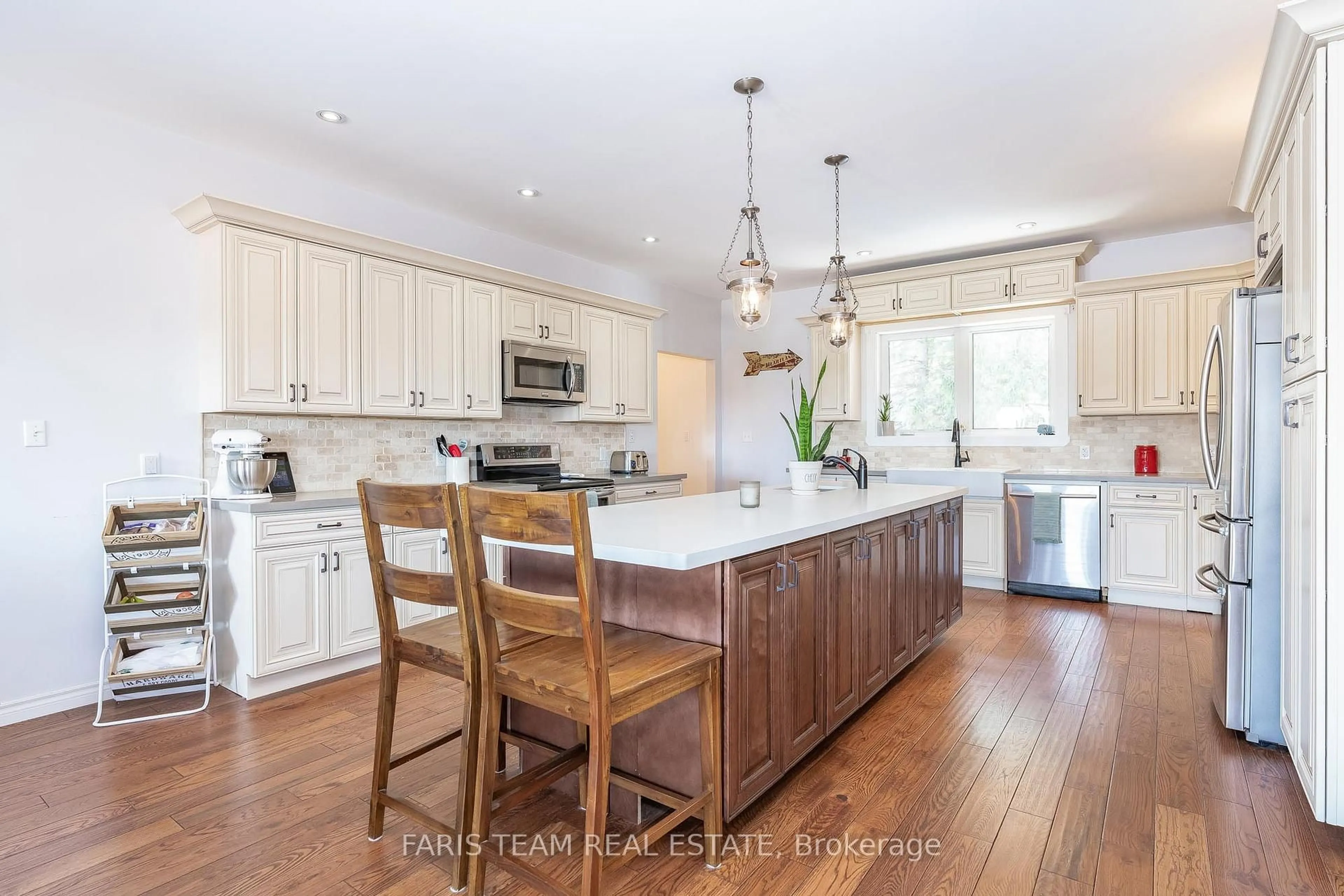 Open concept kitchen, wood/laminate floor for 1933 Vespra Valley Rd, Springwater Ontario L0L 1Y2