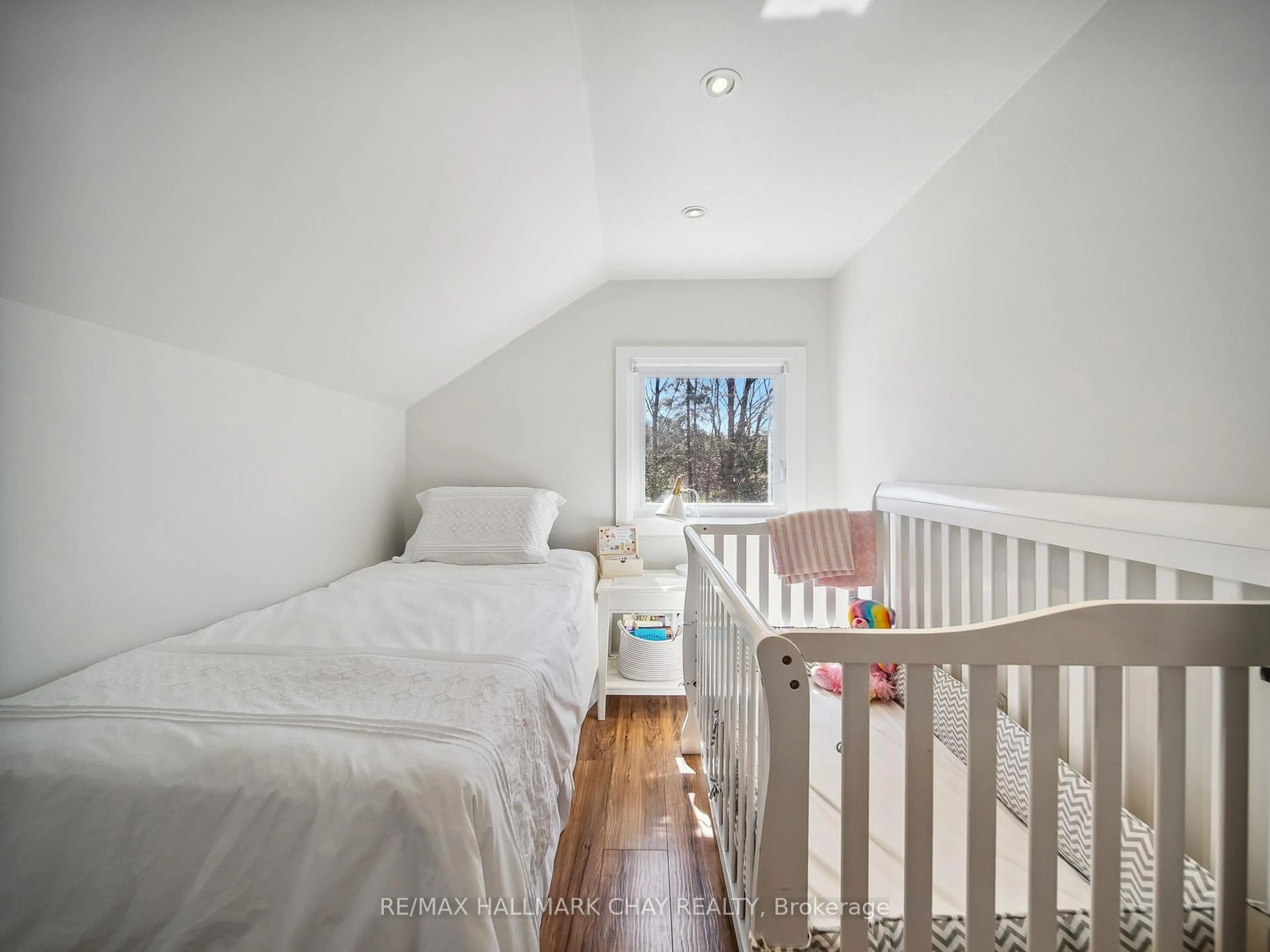 Bedroom with bed, wood/laminate floor for 4539 Penetanguishene Rd, Springwater Ontario L0L 1V0