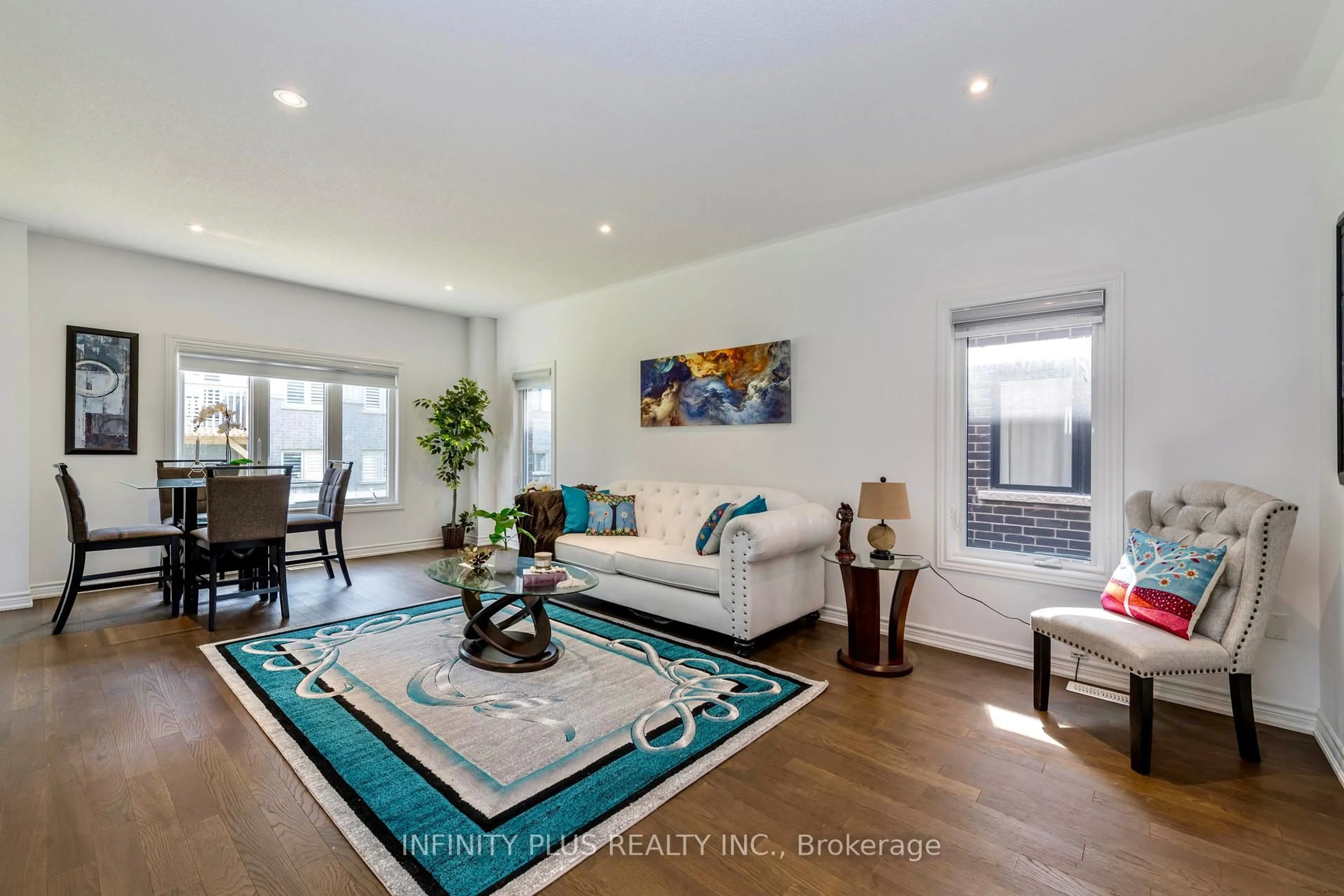 Living room with furniture, wood/laminate floor for 59 Wheatfield Rd, Barrie Ontario L9J 0T4