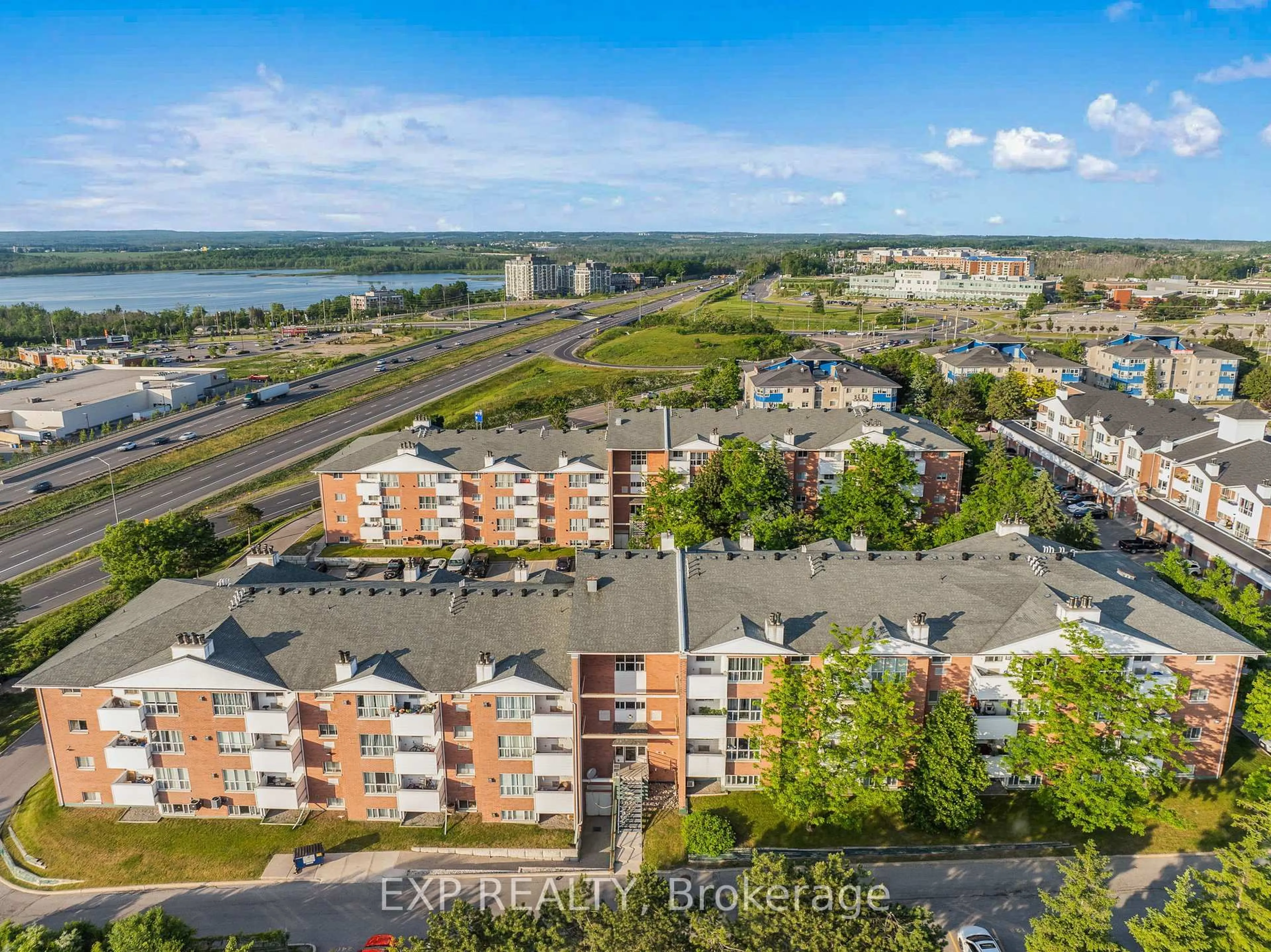 A pic from outside/outdoor area/front of a property/back of a property/a pic from drone, water/lake/river/ocean view for 120 Bell Farm Rd #202, Barrie Ontario L4M 6J2
