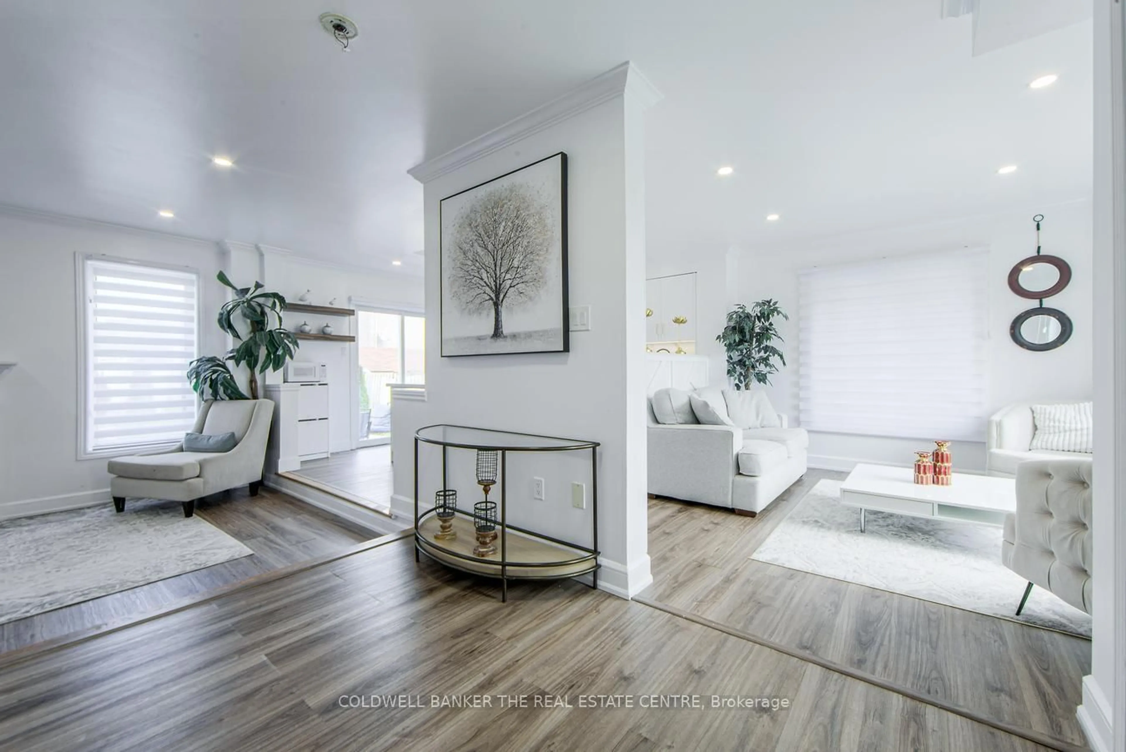 Living room with furniture, wood/laminate floor for 144 Dean Ave, Barrie Ontario L4N 0V7