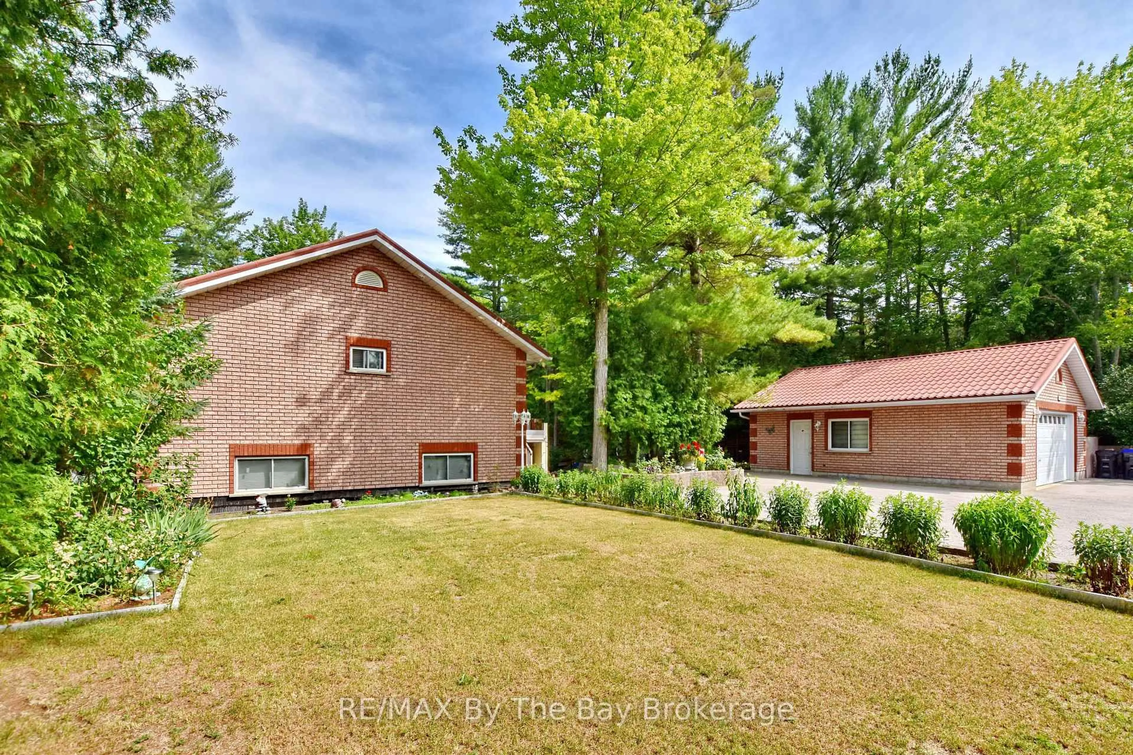 Home with brick exterior material, forest/trees view for 106 Deerbrook Dr, Wasaga Beach Ontario L9Z 2M8