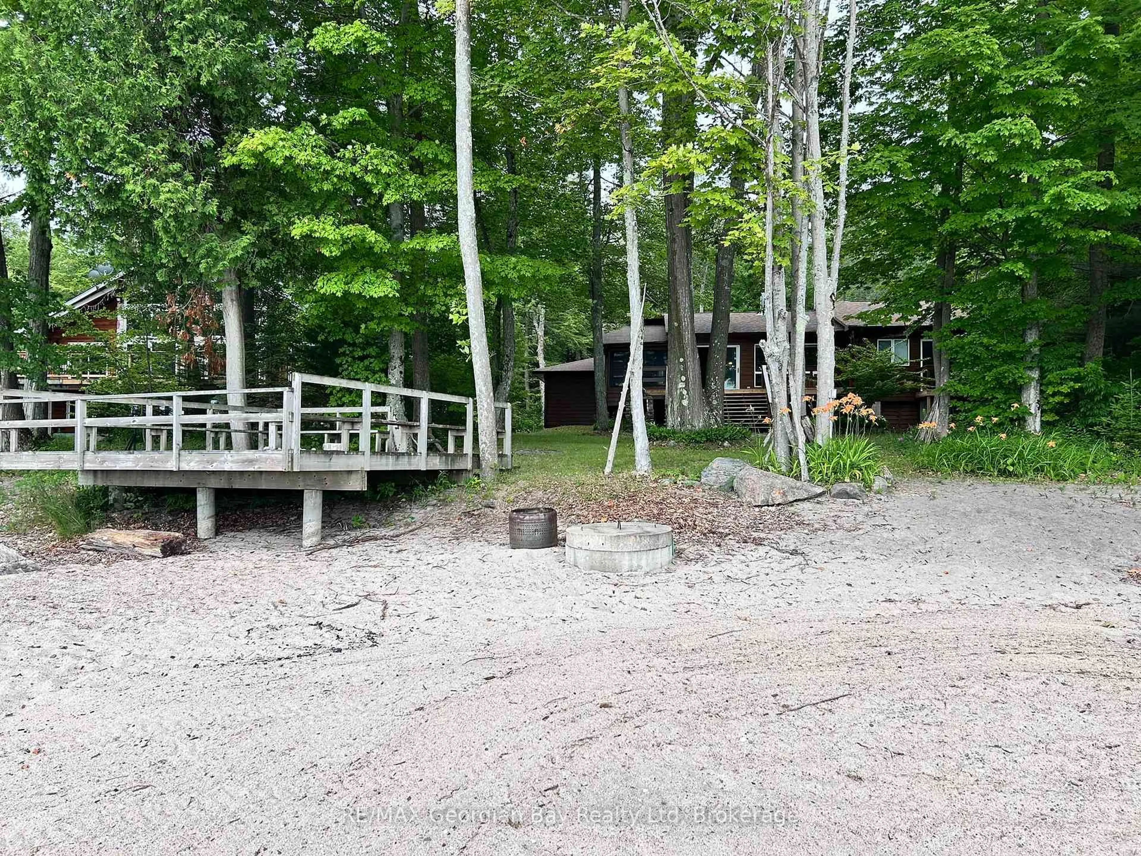 Patio, forest/trees view for 127 Kchi Sin Miikan Rd, Christian Island 30 Ontario L9M 0A9
