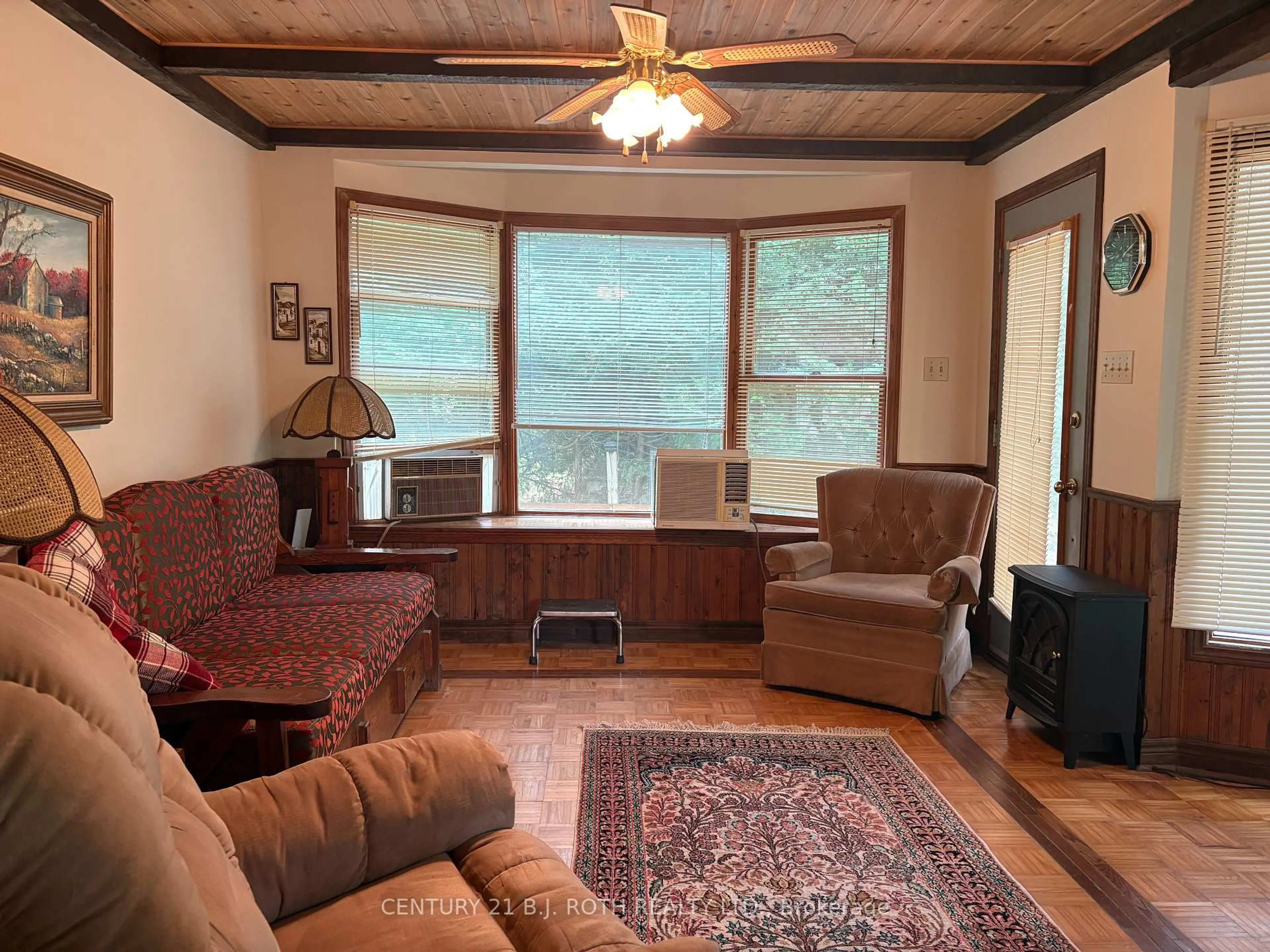 Living room with furniture, wood/laminate floor for 5216 90 County Rd #81, Springwater Ontario L0M 1T2