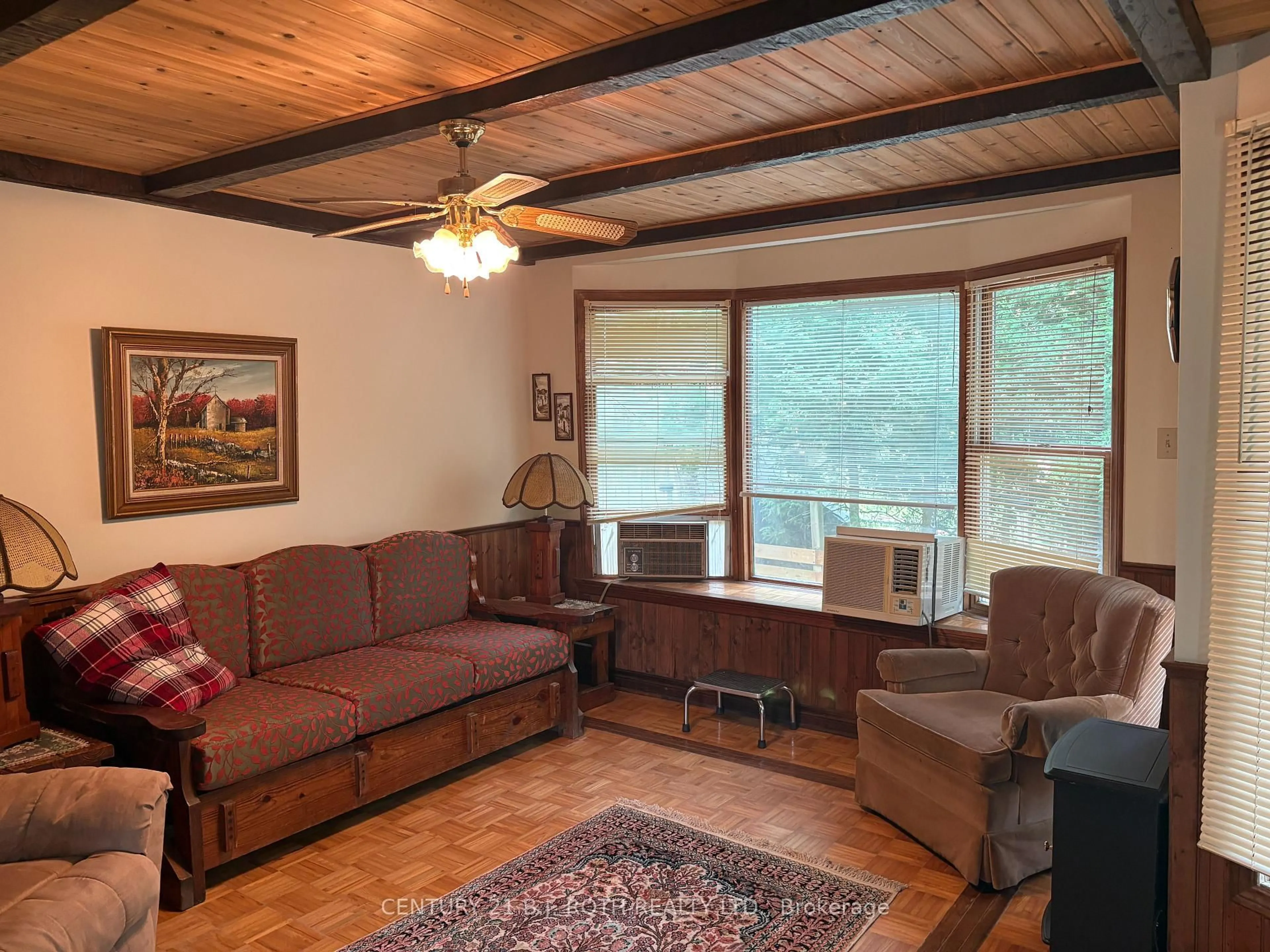 Living room with furniture, wood/laminate floor for 5216 90 County Rd #81, Springwater Ontario L0M 1T2
