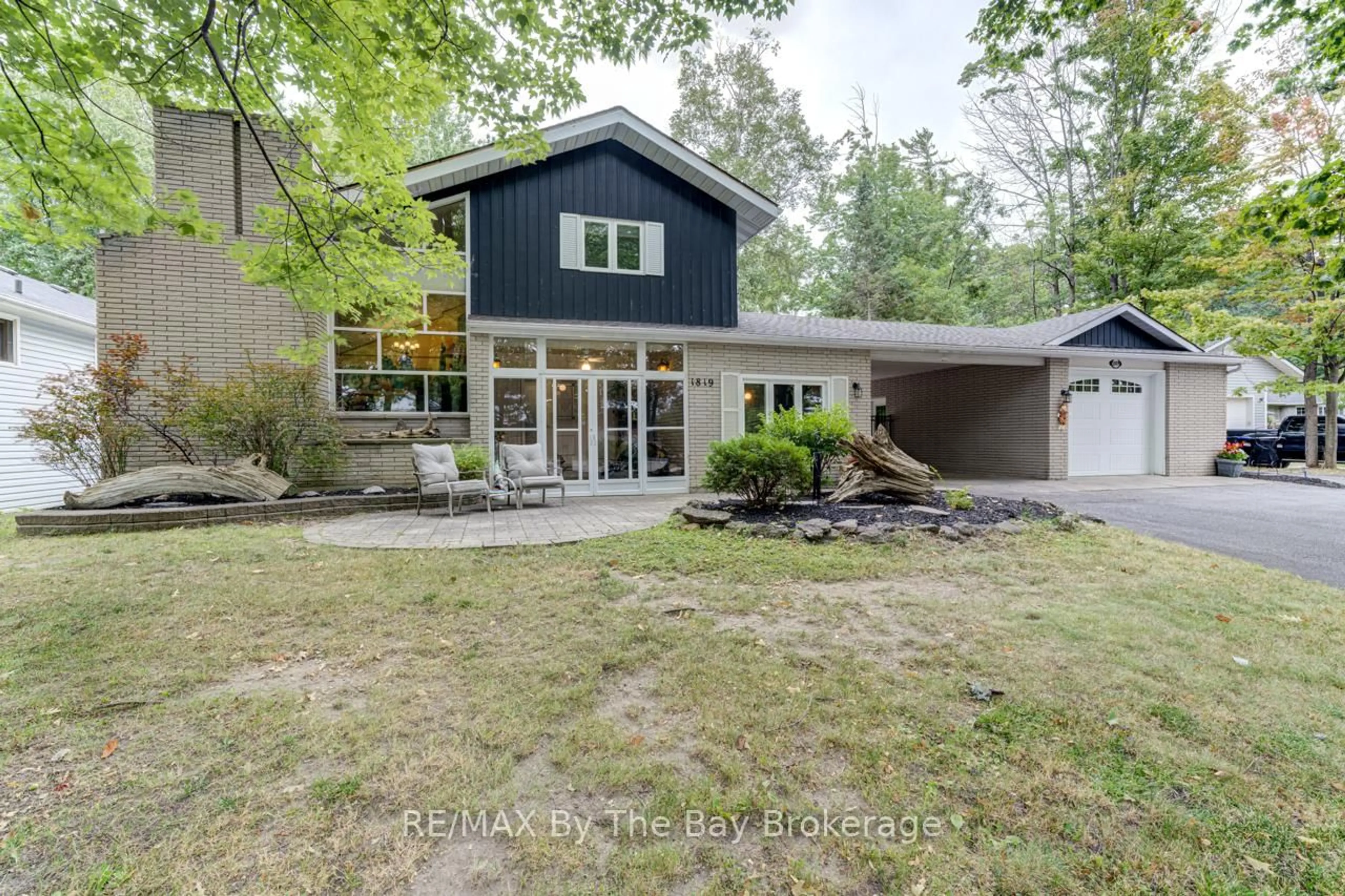 Home with brick exterior material, street for 1819 River Rd, Wasaga Beach Ontario L9Z 2X5