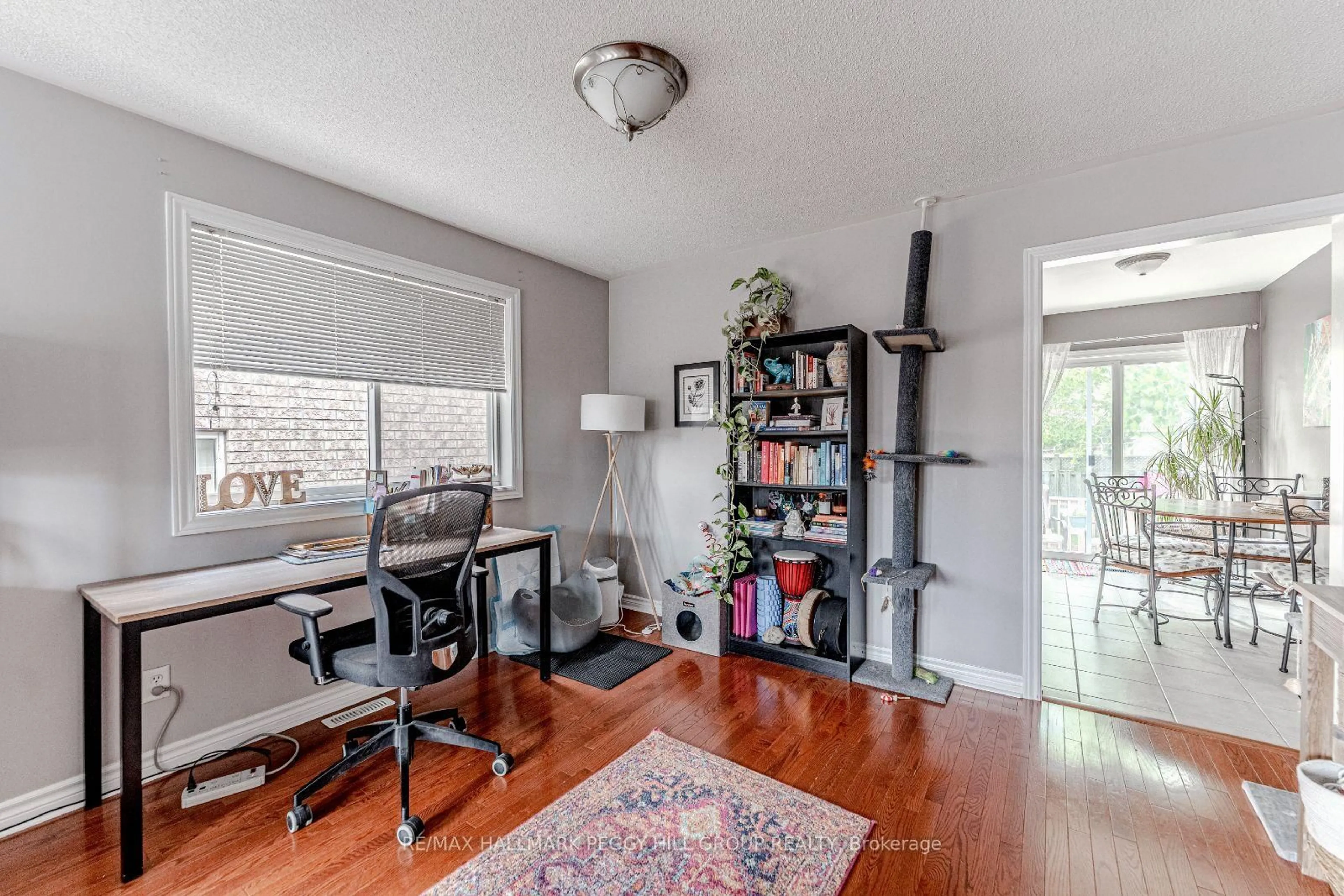 Living room with furniture, wood/laminate floor for 76 Holly Meadow Rd, Barrie Ontario L4N 0A2