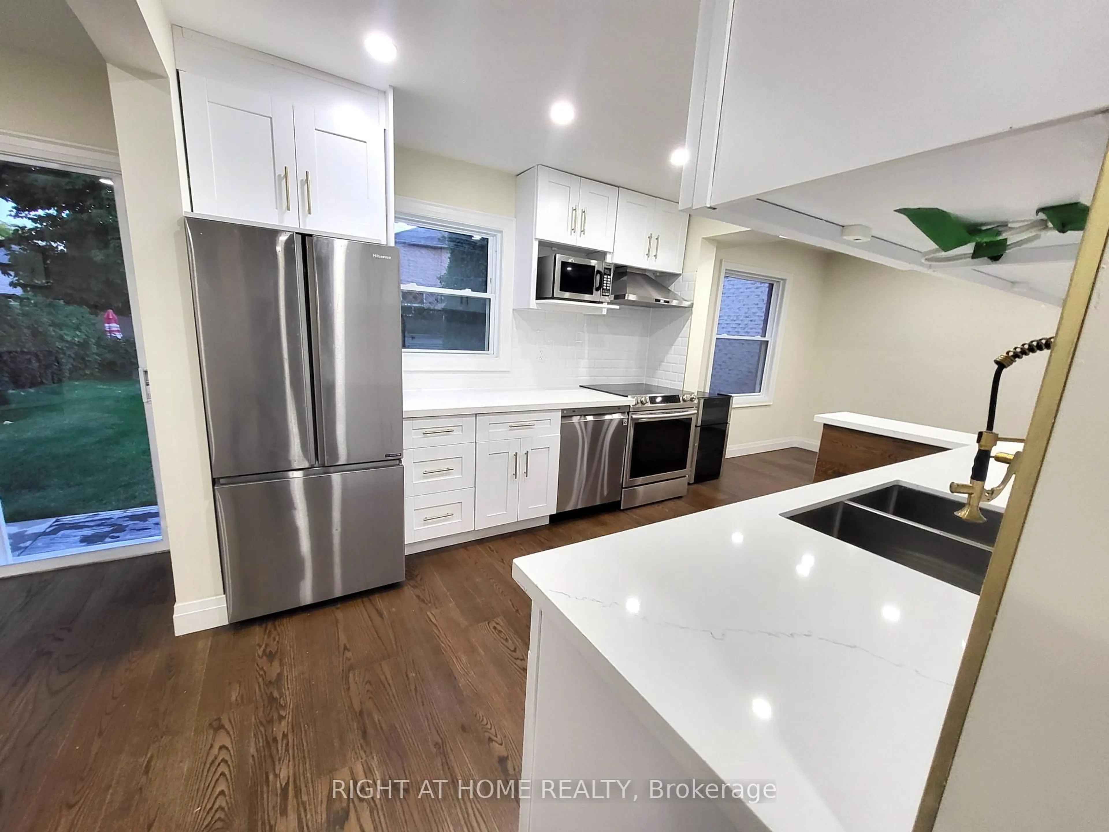 Open concept kitchen, wood/laminate floor for 247 Hickling Tr, Barrie Ontario L4M 5W9