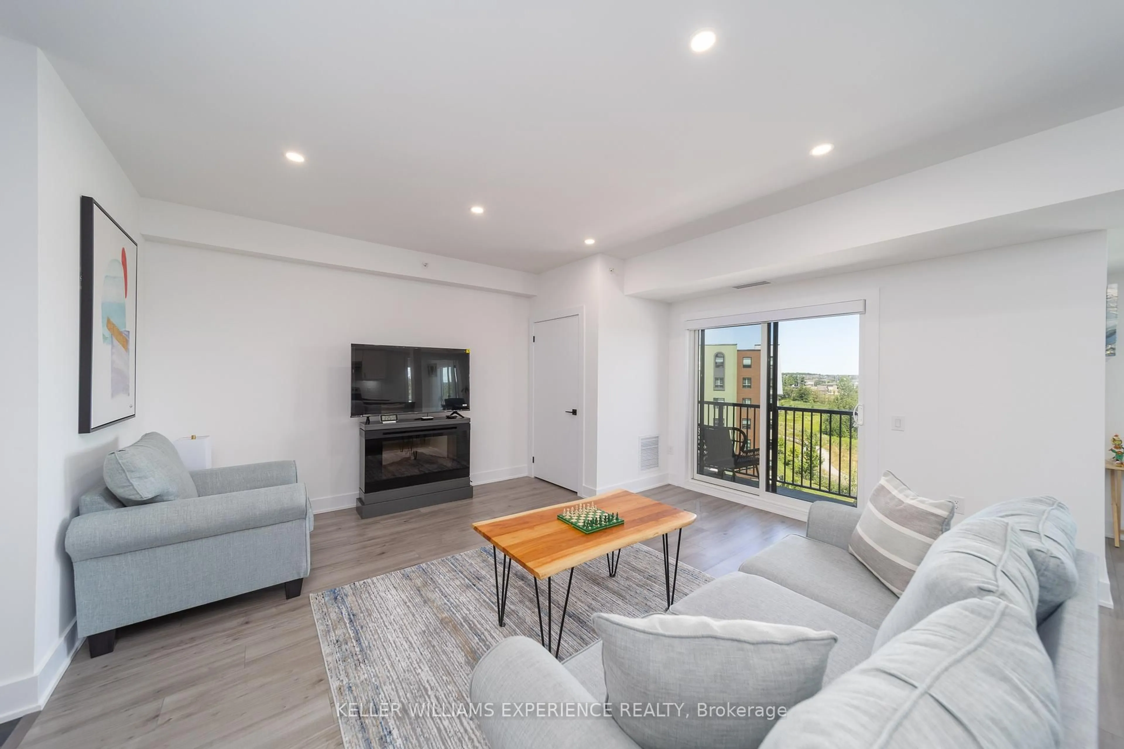 Living room with furniture, wood/laminate floor for 8 Culinary Lane #401, Barrie Ontario L9J 0T2