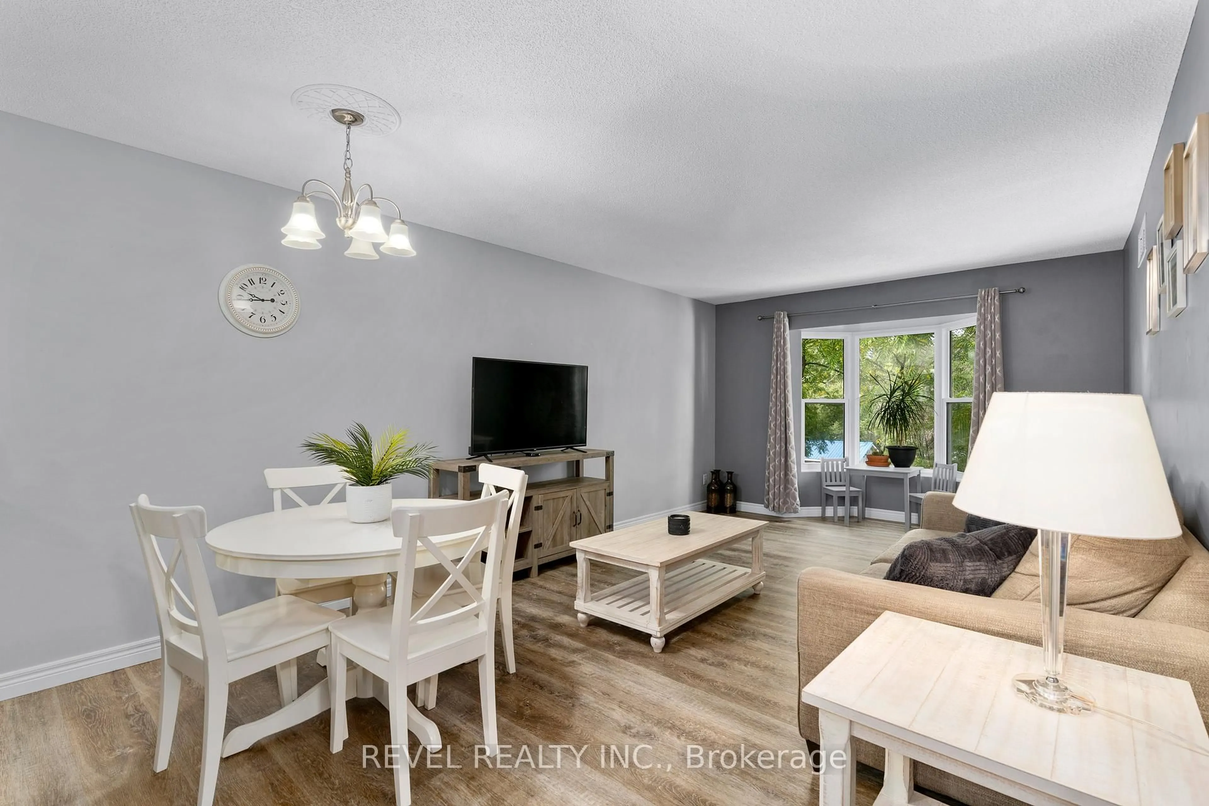 Living room with furniture, wood/laminate floor for 107 Bond St #306, Orillia Ontario L3V 1J7