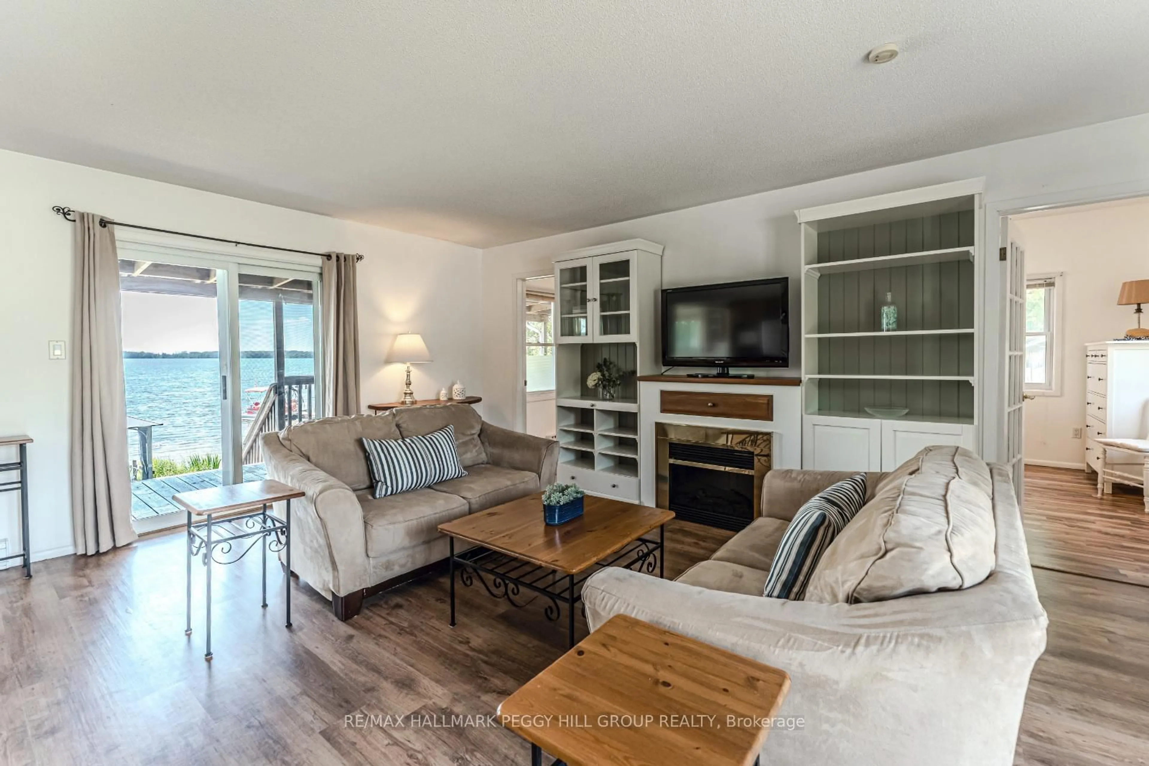 Living room with furniture, wood/laminate floor for 5580 Penetanguishene Rd, Springwater Ontario L0L 1P0