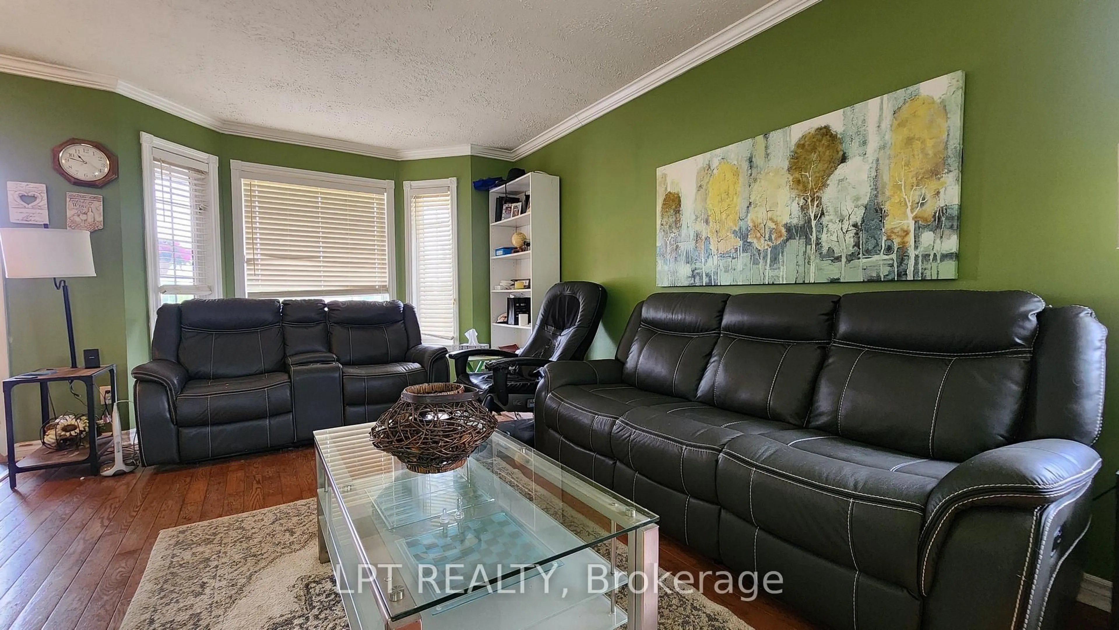 Living room with furniture, wood/laminate floor for 69 Simcoe St, Springwater Ontario L0L 1P0