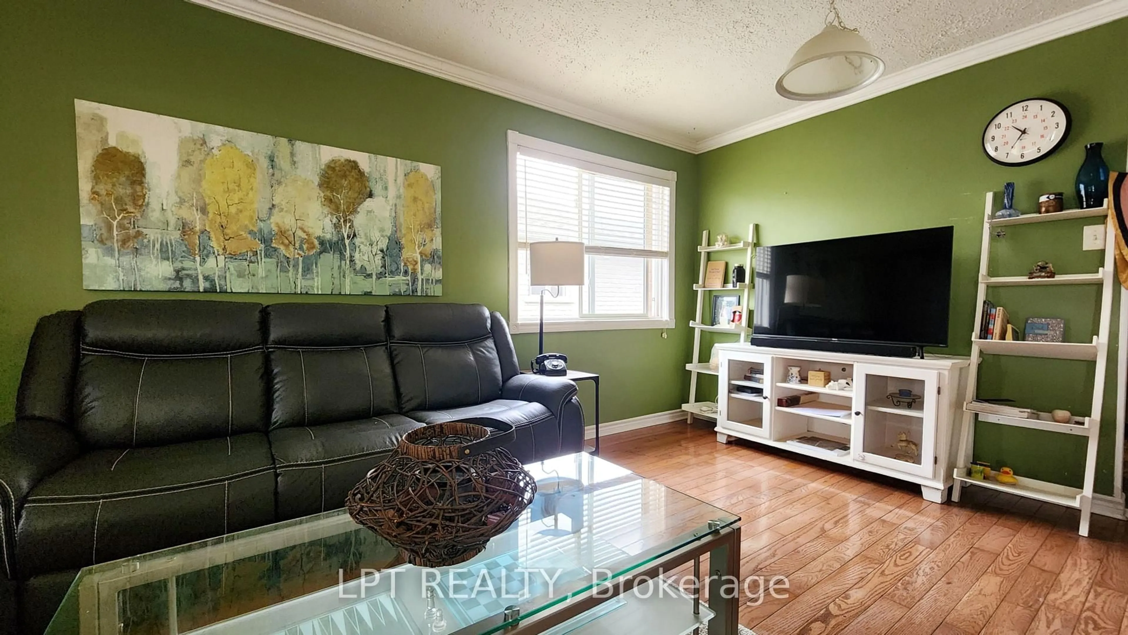 Living room with furniture, wood/laminate floor for 69 Simcoe St, Springwater Ontario L0L 1P0