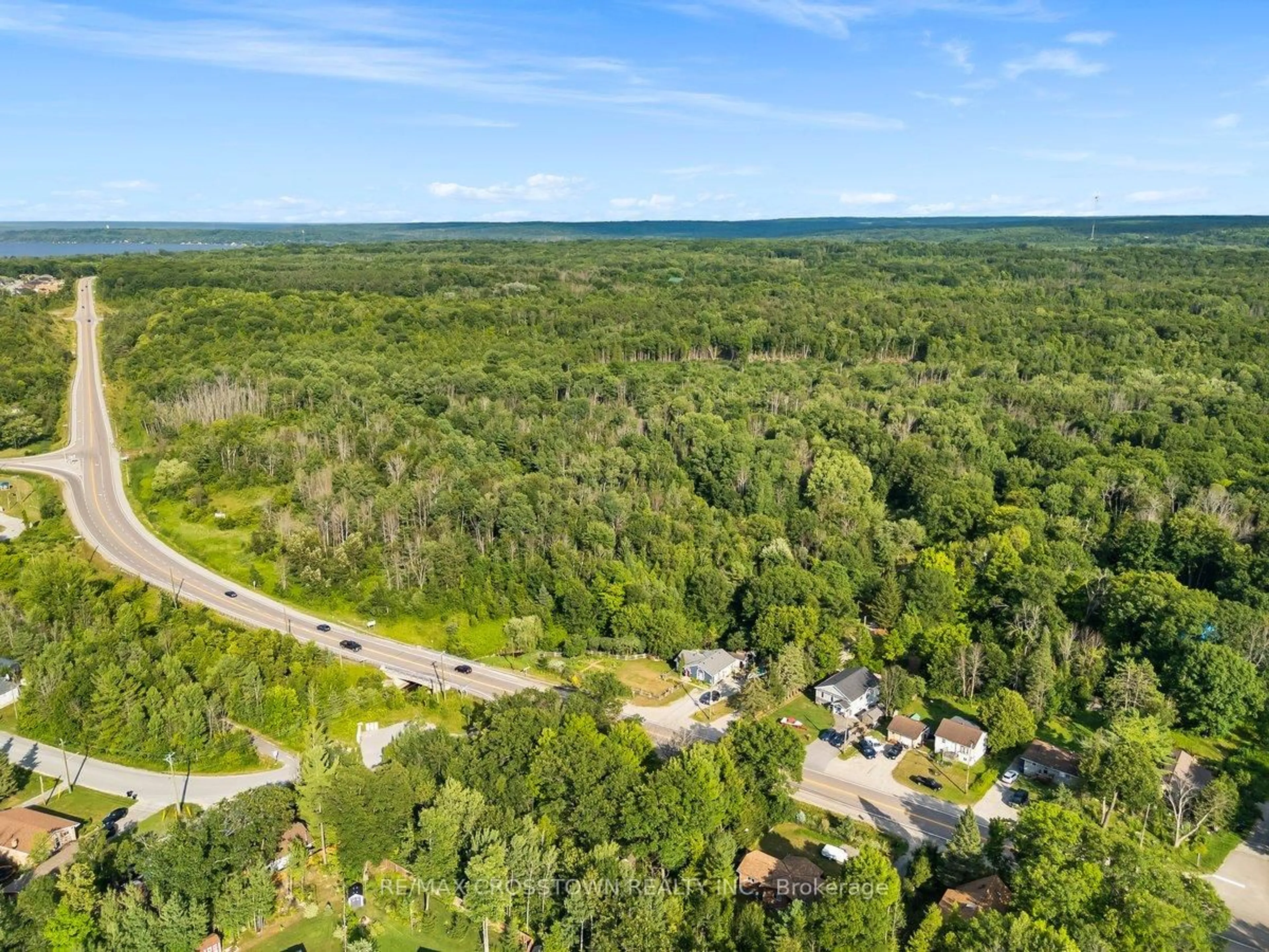 A pic from outside/outdoor area/front of a property/back of a property/a pic from drone, forest/trees view for 15205 Highway 12, Tay Ontario 00000