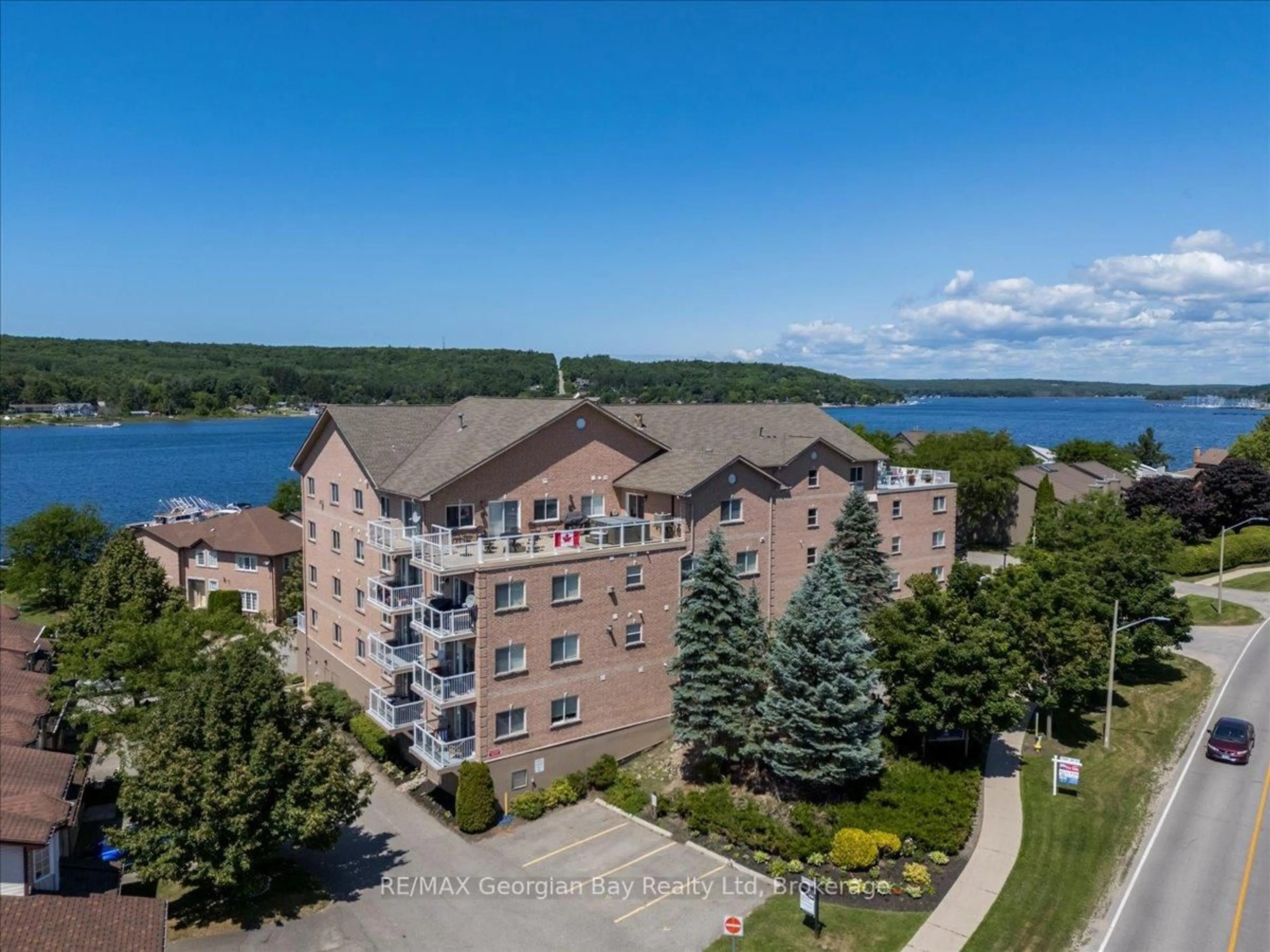 A pic from outside/outdoor area/front of a property/back of a property/a pic from drone, water/lake/river/ocean view for 4 Beck Blvd #201, Penetanguishene Ontario L9M 2H3