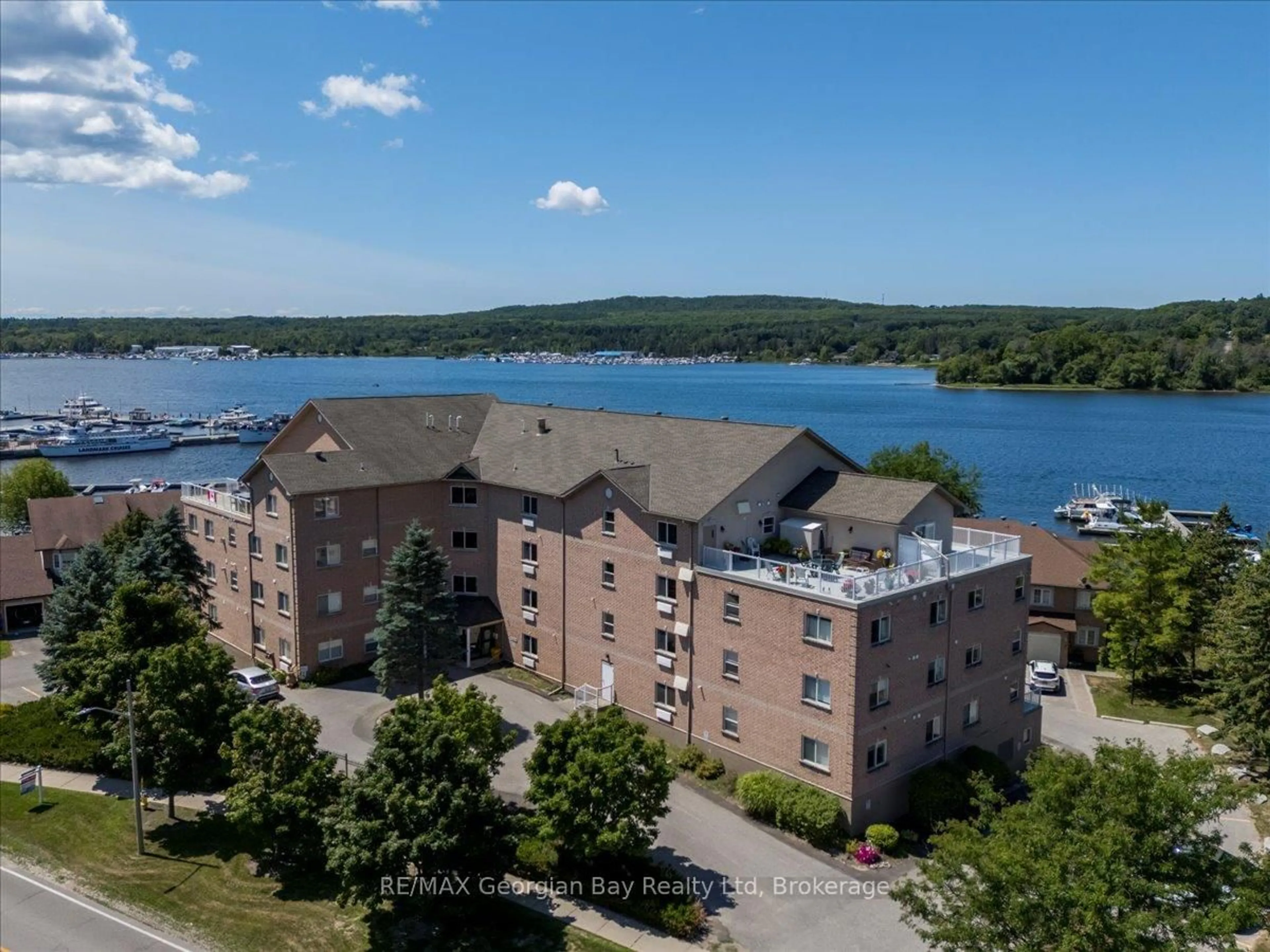 A pic from outside/outdoor area/front of a property/back of a property/a pic from drone, water/lake/river/ocean view for 4 Beck Blvd #201, Penetanguishene Ontario L9M 2H3