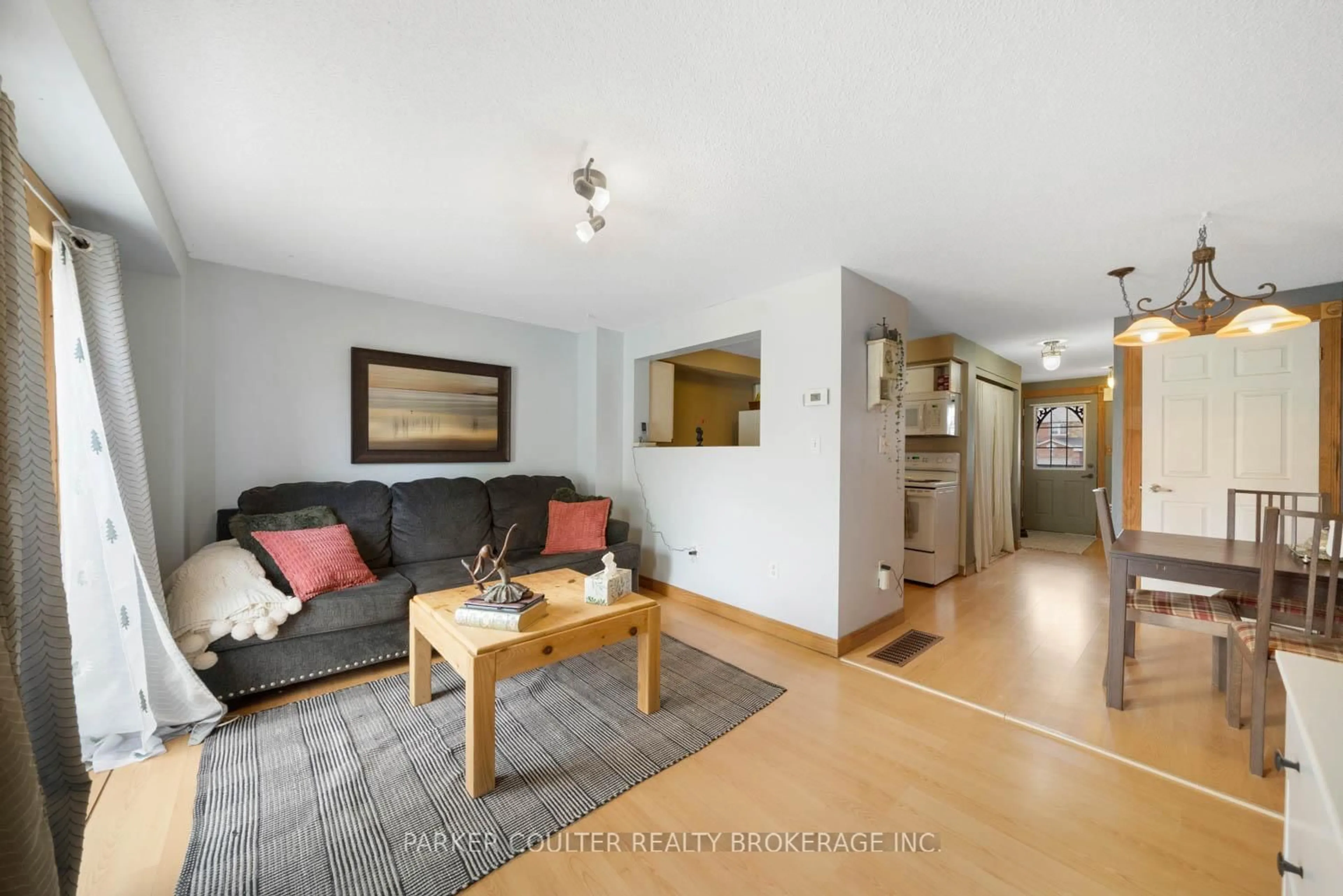 Living room with furniture, wood/laminate floor for 96 Lee Cres, Barrie Ontario L4N 9Z1
