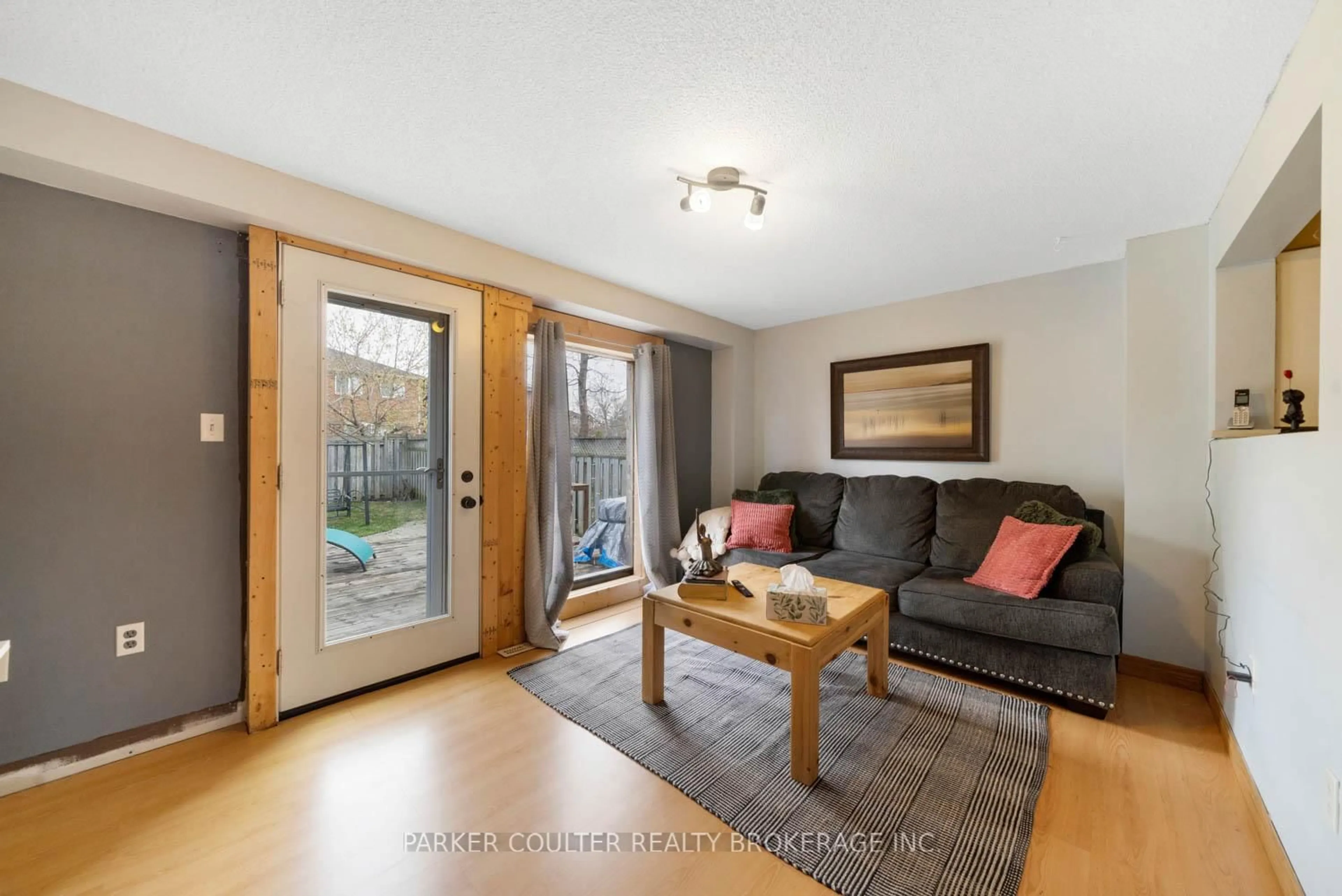 Living room with furniture, wood/laminate floor for 96 Lee Cres, Barrie Ontario L4N 9Z1