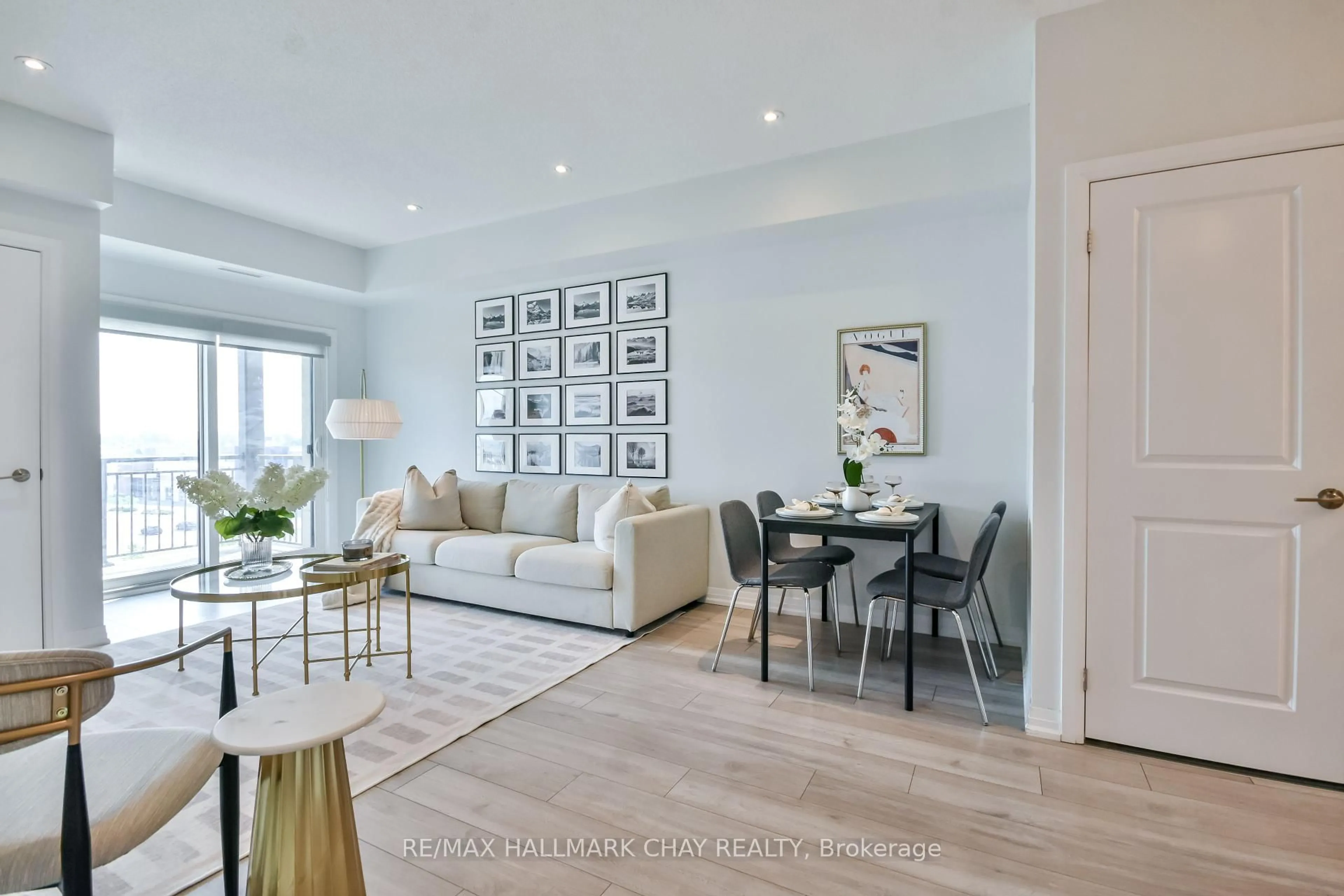Living room with furniture, wood/laminate floor for 299 Cundles Rd #507, Barrie Ontario L4M 0K9