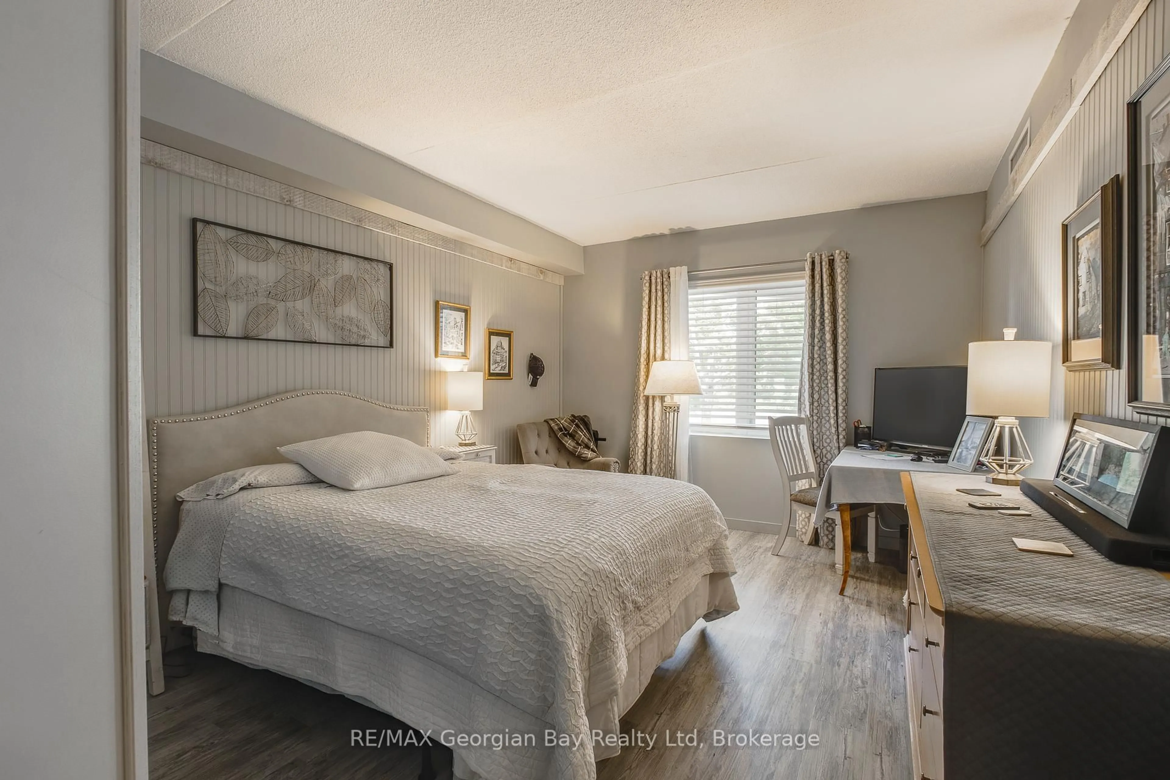 Bedroom with bed, wood/laminate floor for 11 Beck Blvd #102, Penetanguishene Ontario L9M 2G1