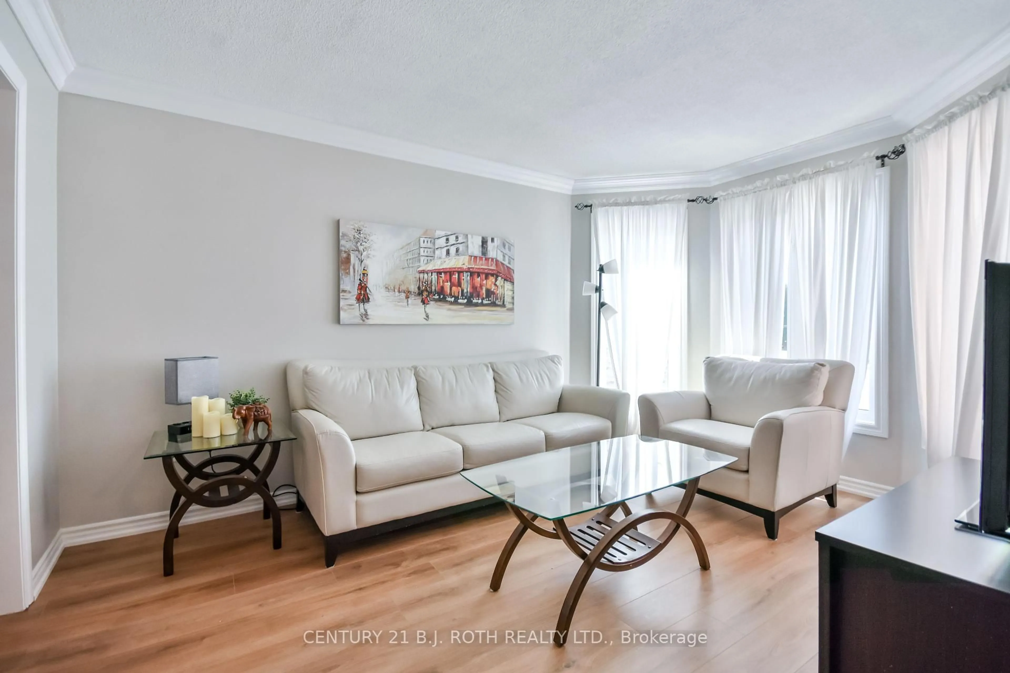 Living room with furniture, wood/laminate floor for 28 Shaina Crt, Barrie Ontario L4N 9S7