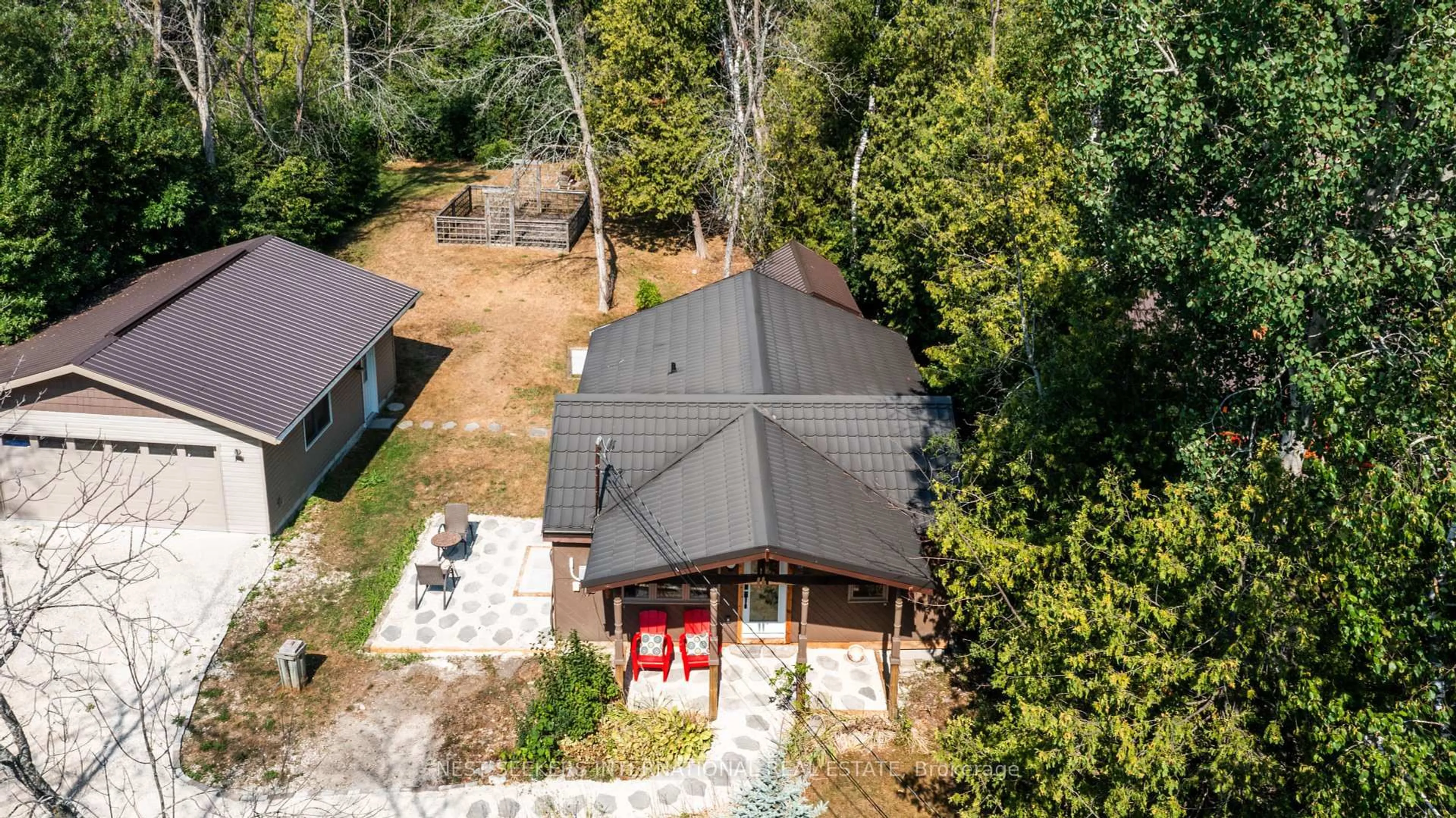 A pic from outside/outdoor area/front of a property/back of a property/a pic from drone, forest/trees view for 15 Edgar Rd, Collingwood Ontario L9Y 3Z1