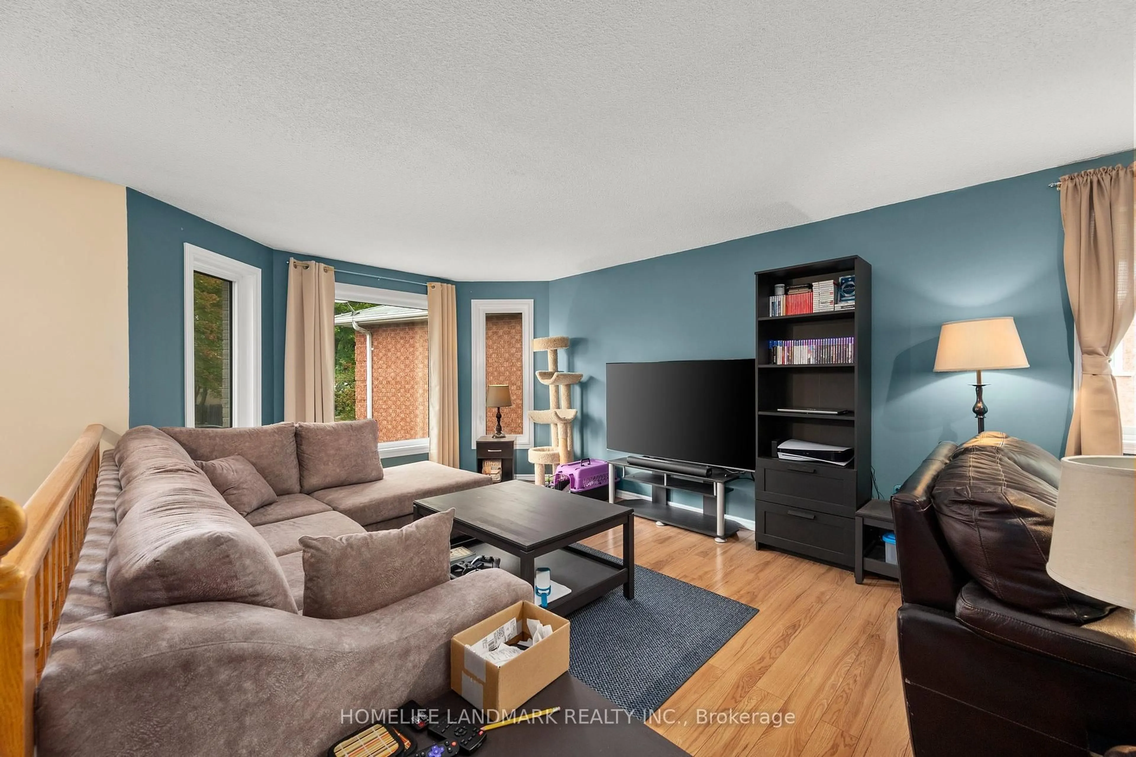 Living room with furniture, wood/laminate floor for 196 Columbia Rd, Barrie Ontario L4N 8C9