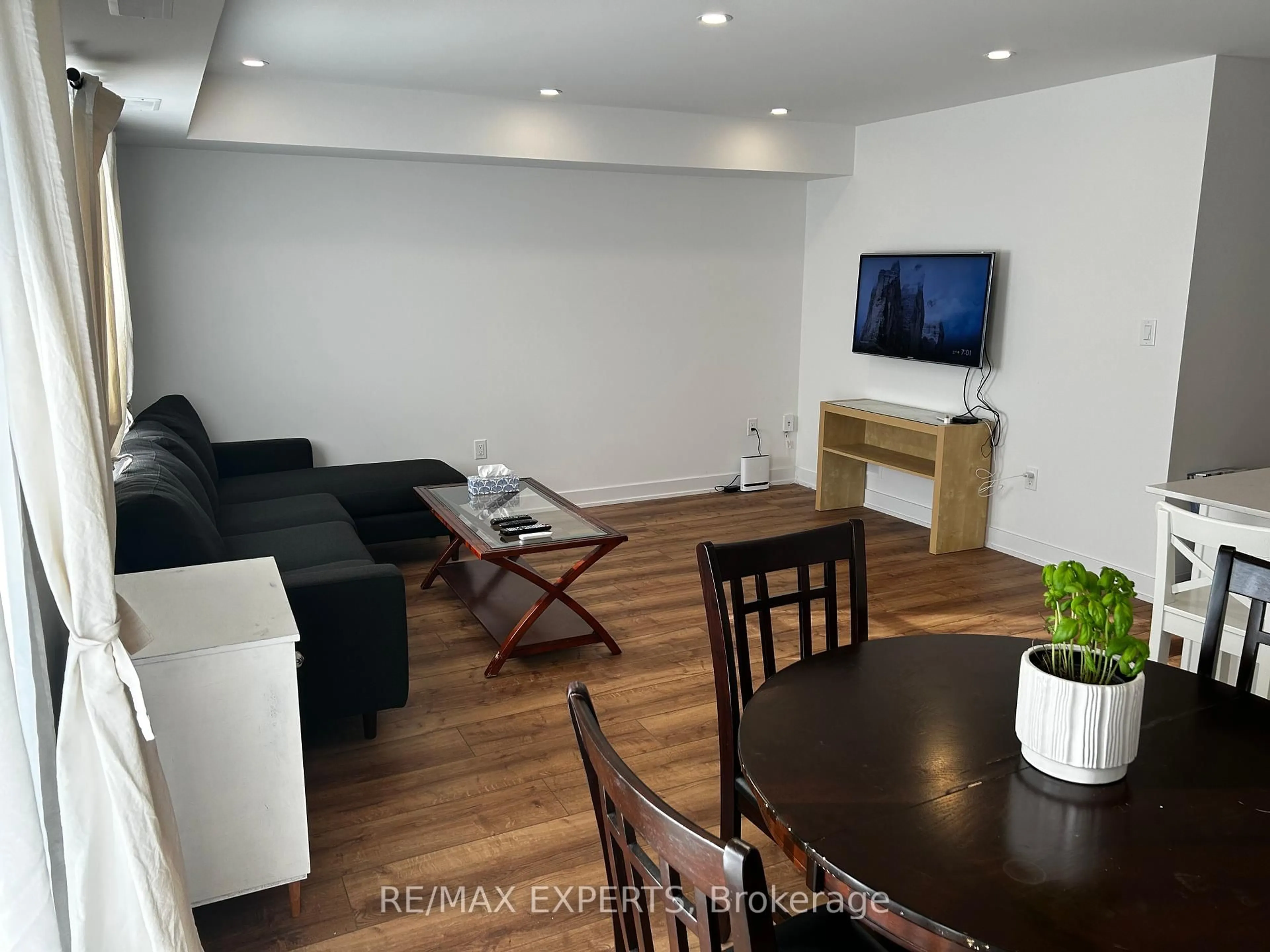 Living room with furniture, wood/laminate floor for 32 Wagon Lane #30, Barrie Ontario L9J 0C2