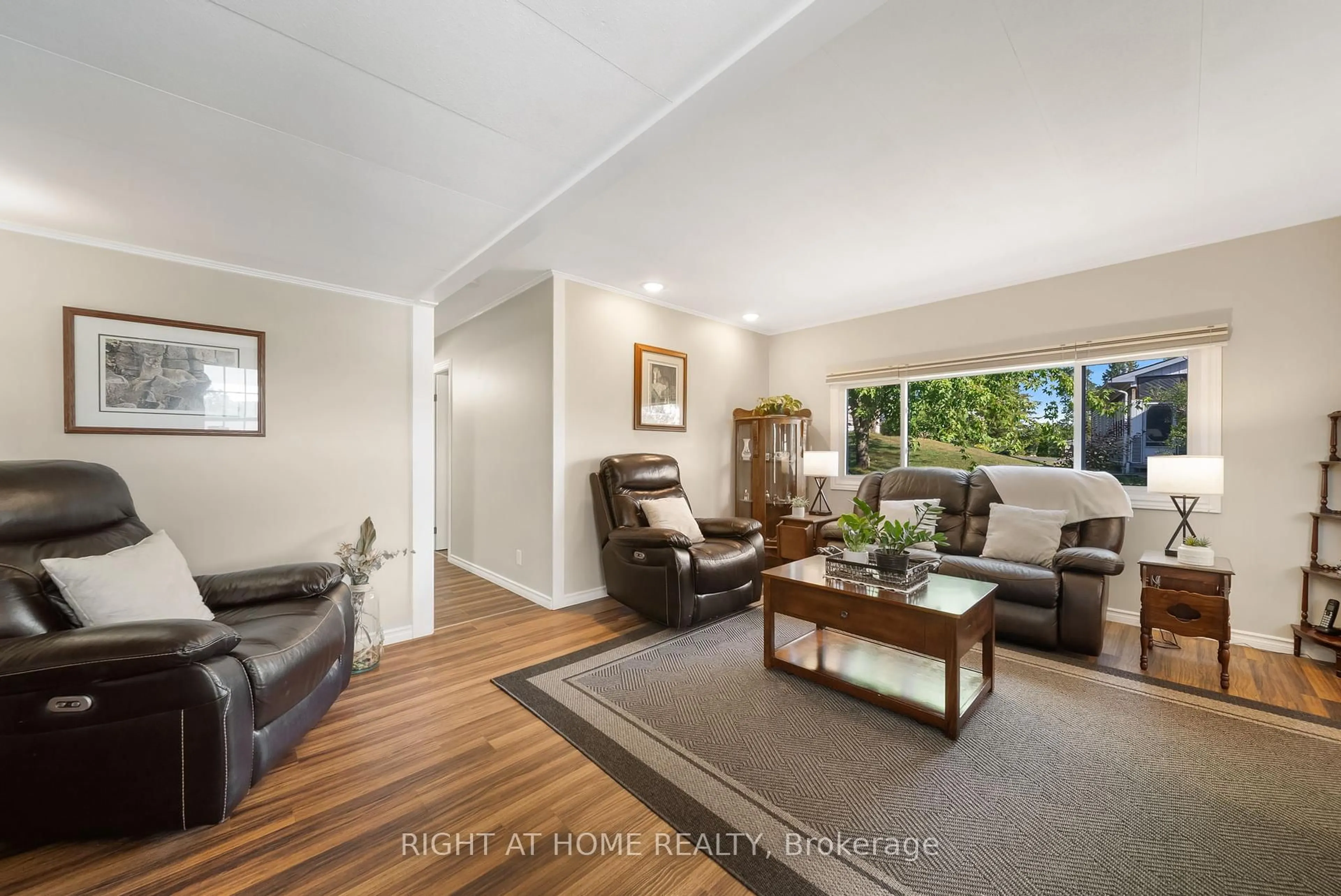 Living room with furniture, wood/laminate floor for 66 Cameron Dr, Oro-Medonte Ontario L0L 1T0