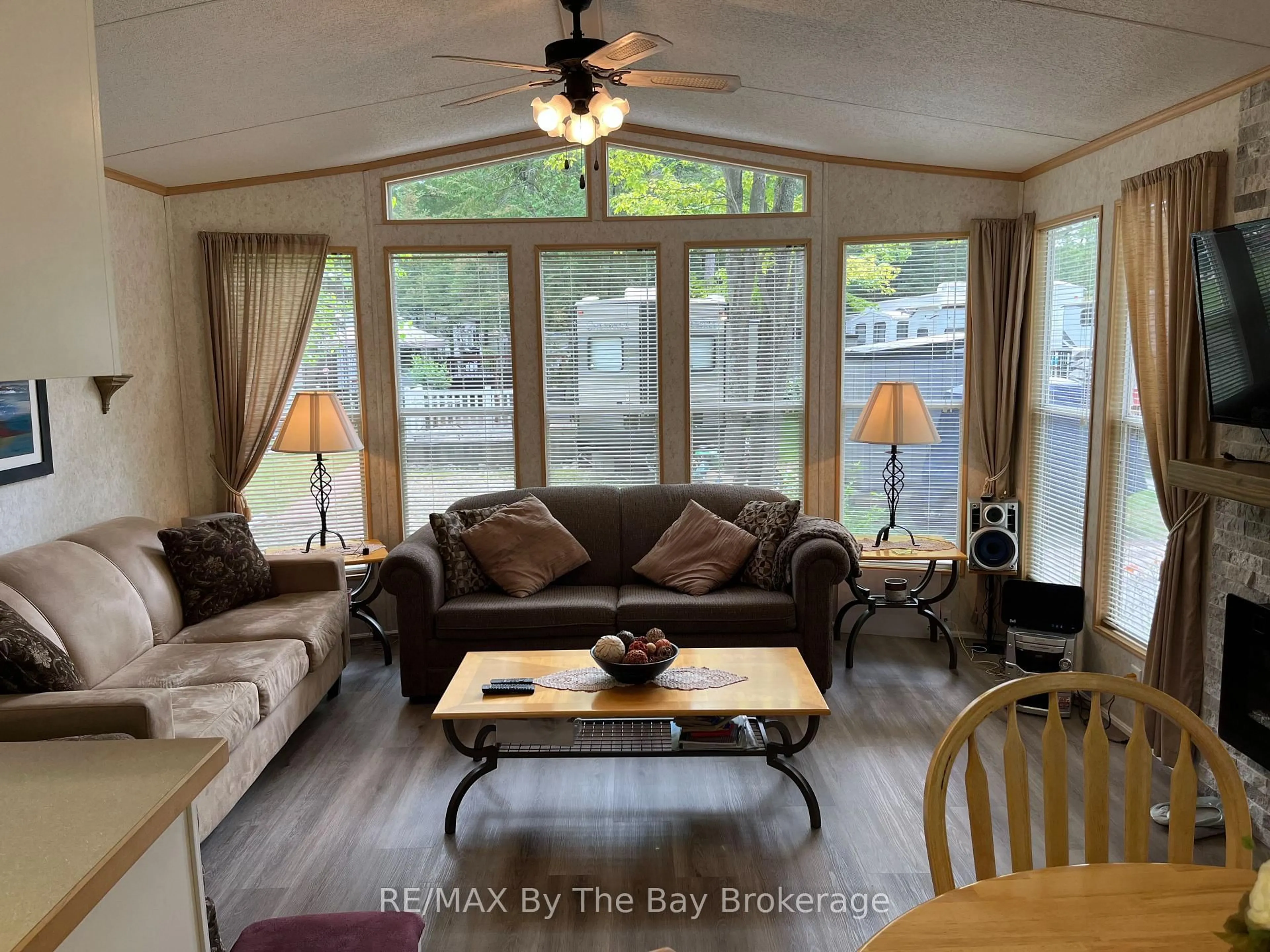 Living room with furniture, wood/laminate floor for 85 Theme Park Dr #247, Wasaga Beach Ontario L9Z 1X7