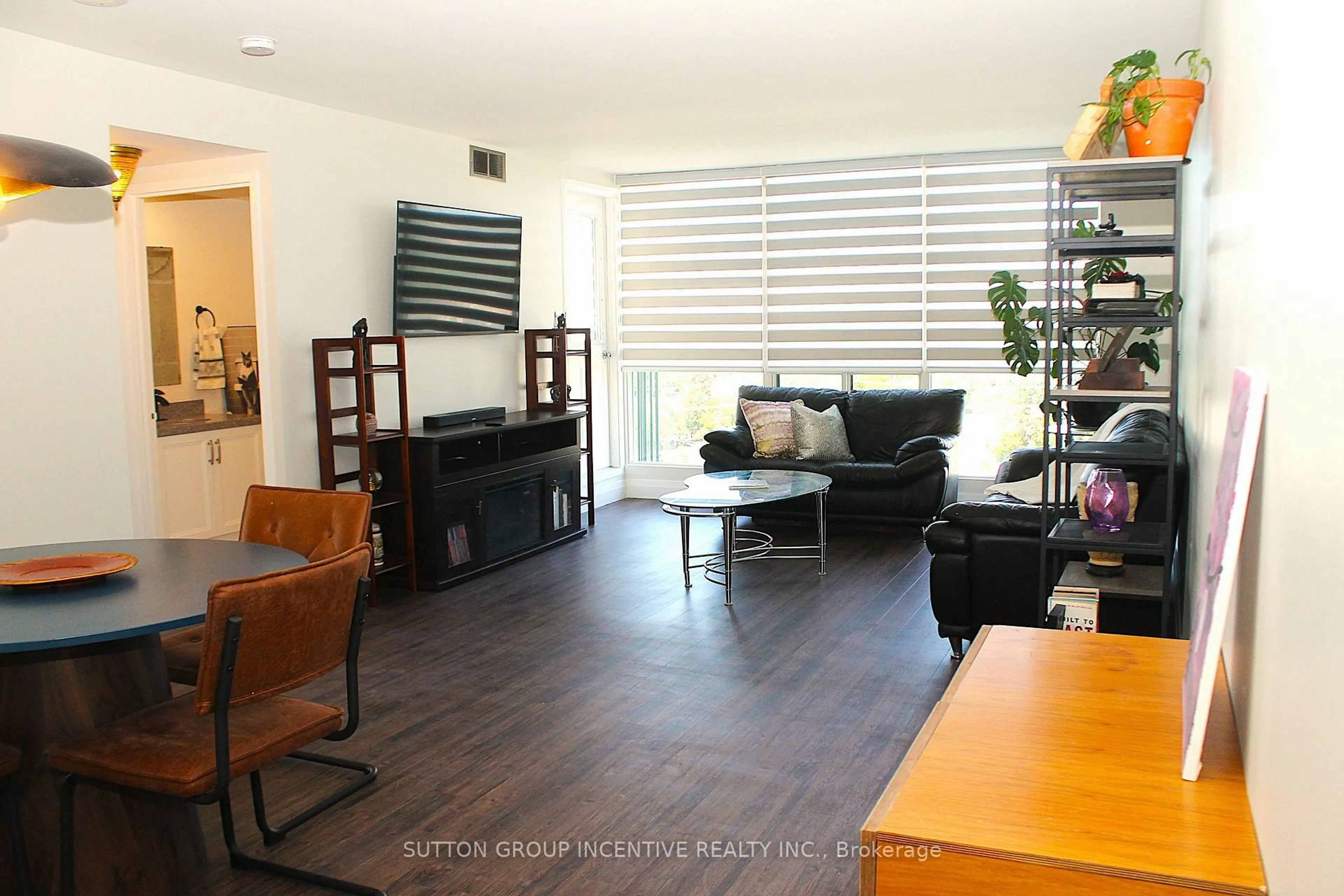 Living room with furniture, wood/laminate floor for 65 Ellen St #708, Barrie Ontario L4N 3A5