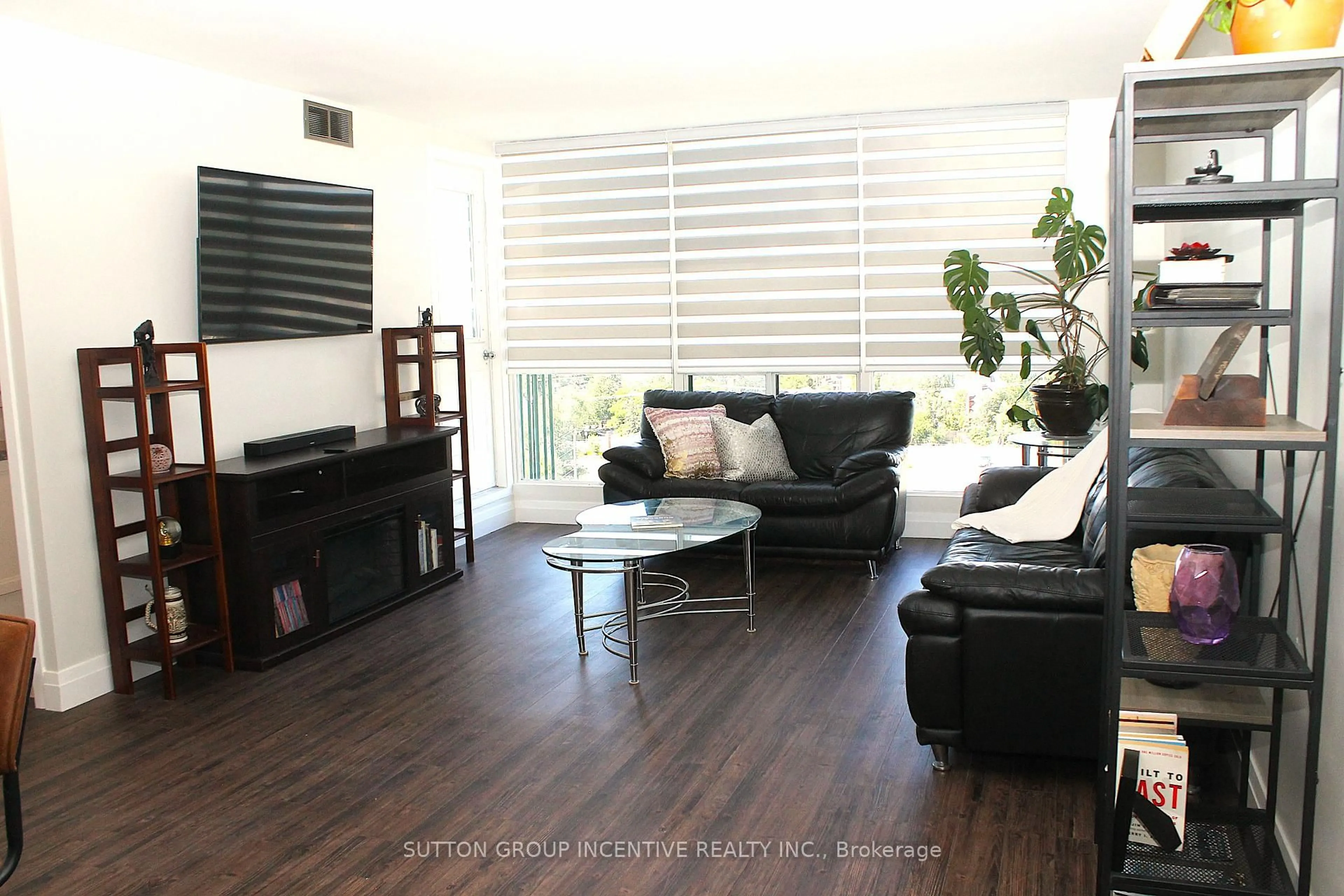 Living room with furniture, wood/laminate floor for 65 Ellen St #708, Barrie Ontario L4N 3A5