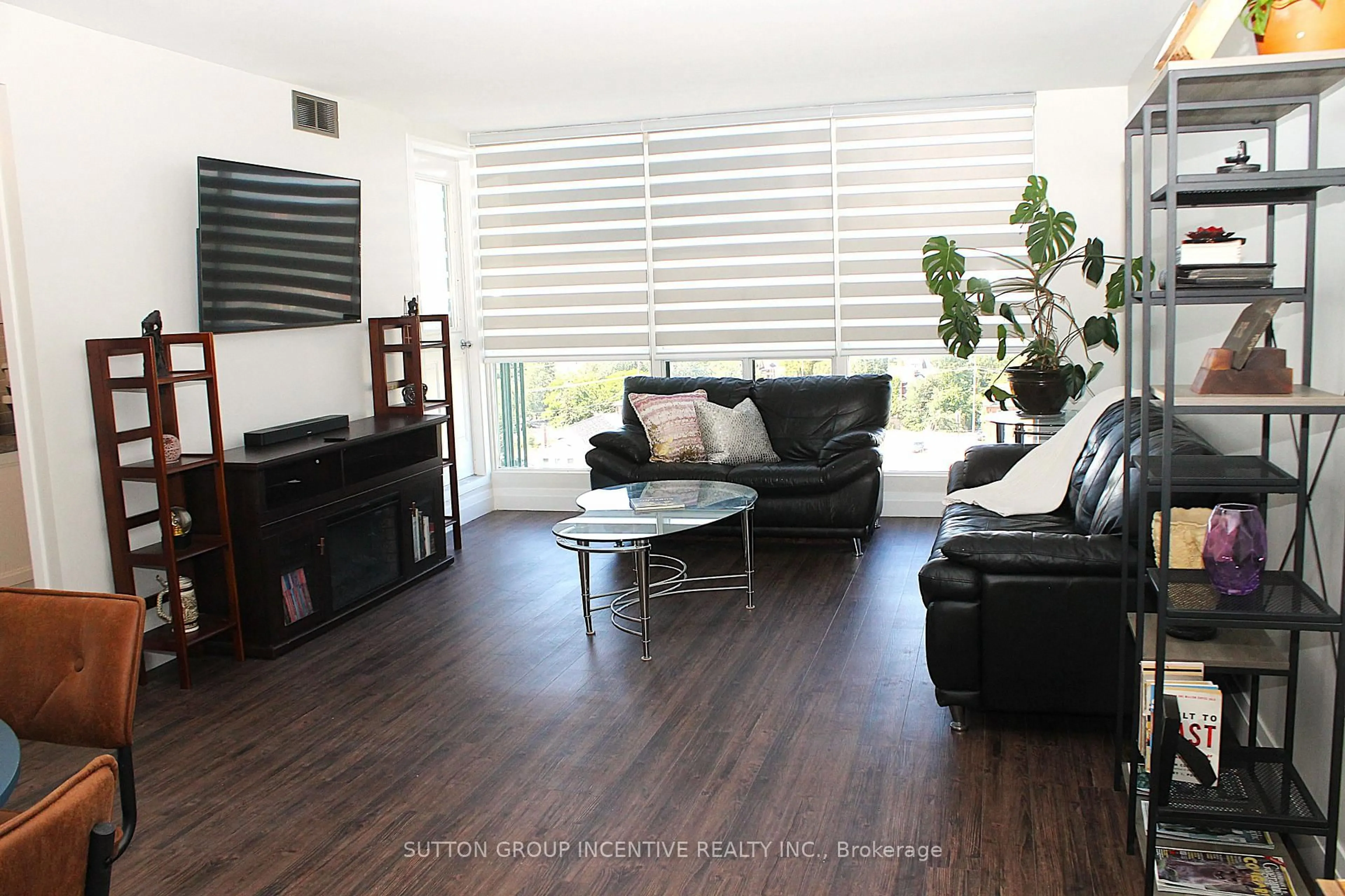 Living room with furniture, wood/laminate floor for 65 Ellen St #708, Barrie Ontario L4N 3A5