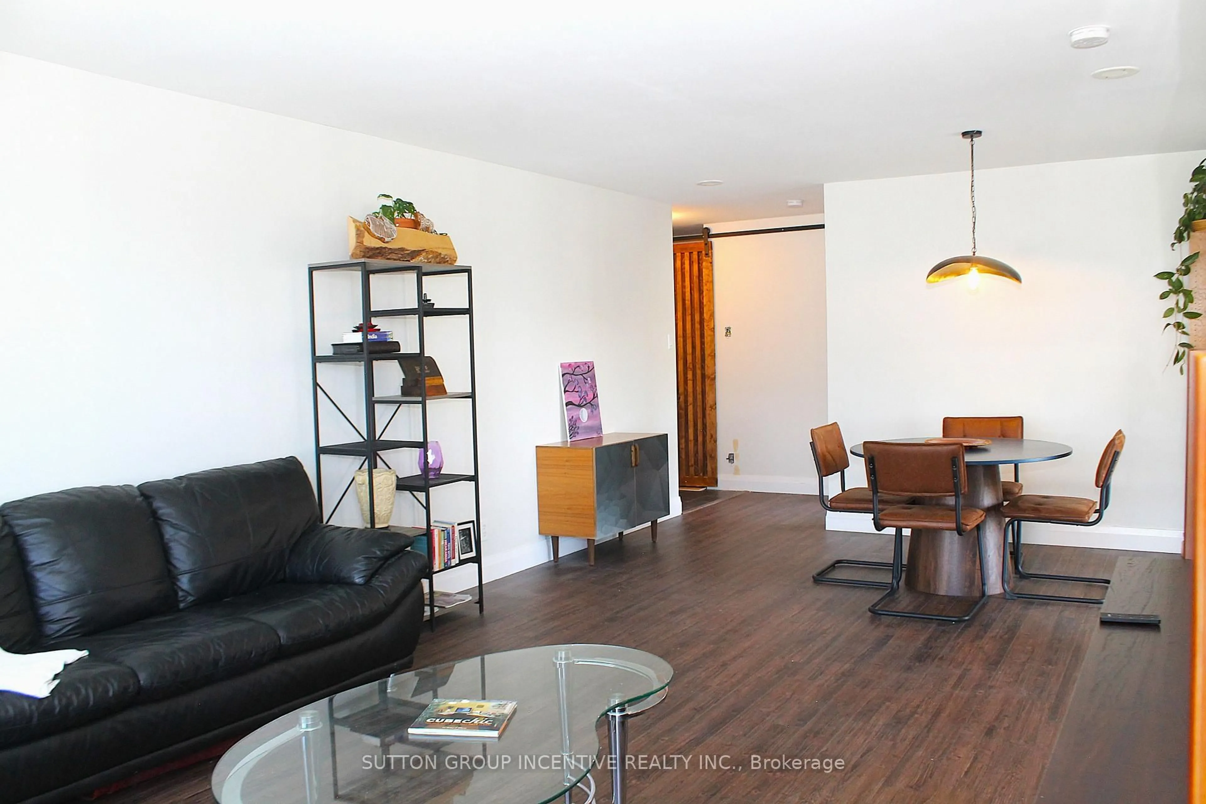 Living room with furniture, wood/laminate floor for 65 Ellen St #708, Barrie Ontario L4N 3A5